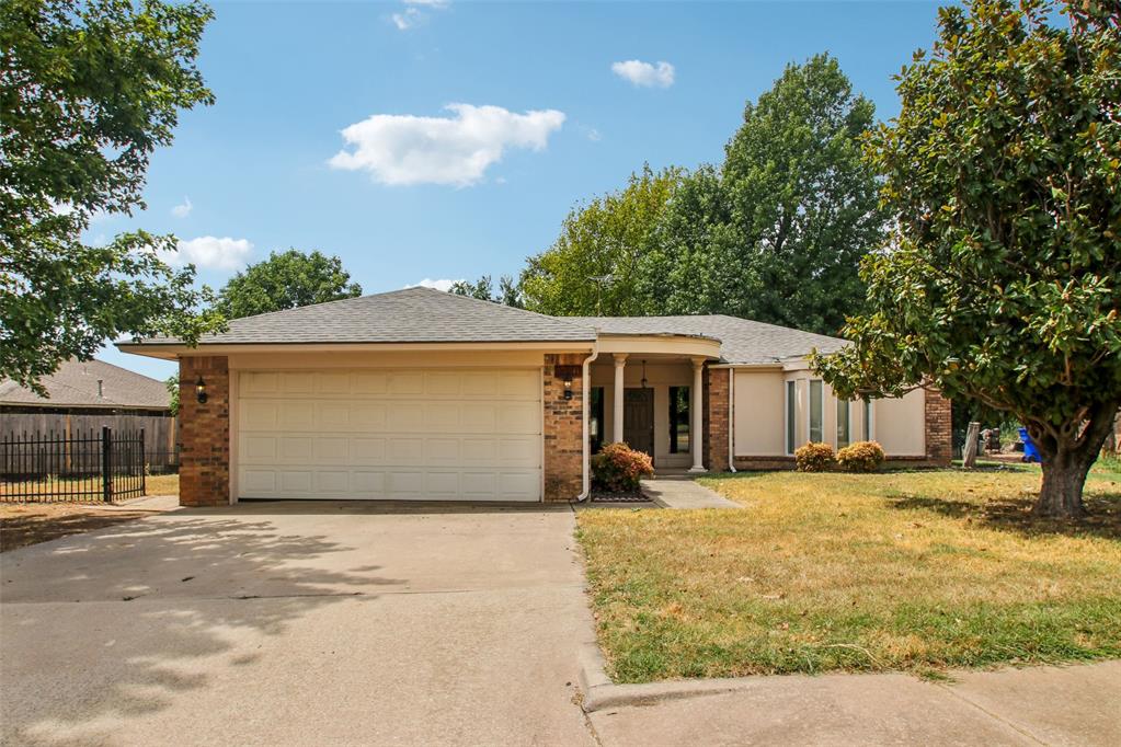 This Norman home brings single-level living together with mature trees, an attached garage, and a backyard courtyard with patio access from the main living area. Inside, vaulted ceilings, wood-look flooring, built-ins, and a fireplace create a comfortable central gathering space. The kitchen features warm wood cabinetry, tile flooring, dark counters, and a sunny breakfast nook with bay-style windows. Bedrooms include fresh carpet and neutral paint, while the bathrooms provide updated shower and vanity spaces. Recent work included roof replacement, interior paint, carpet installation, tub reglazing, and cleaning, giving the home a refreshed feel with practical indoor and outdoor areas. Included 100-Day Home Warranty with buyer activation