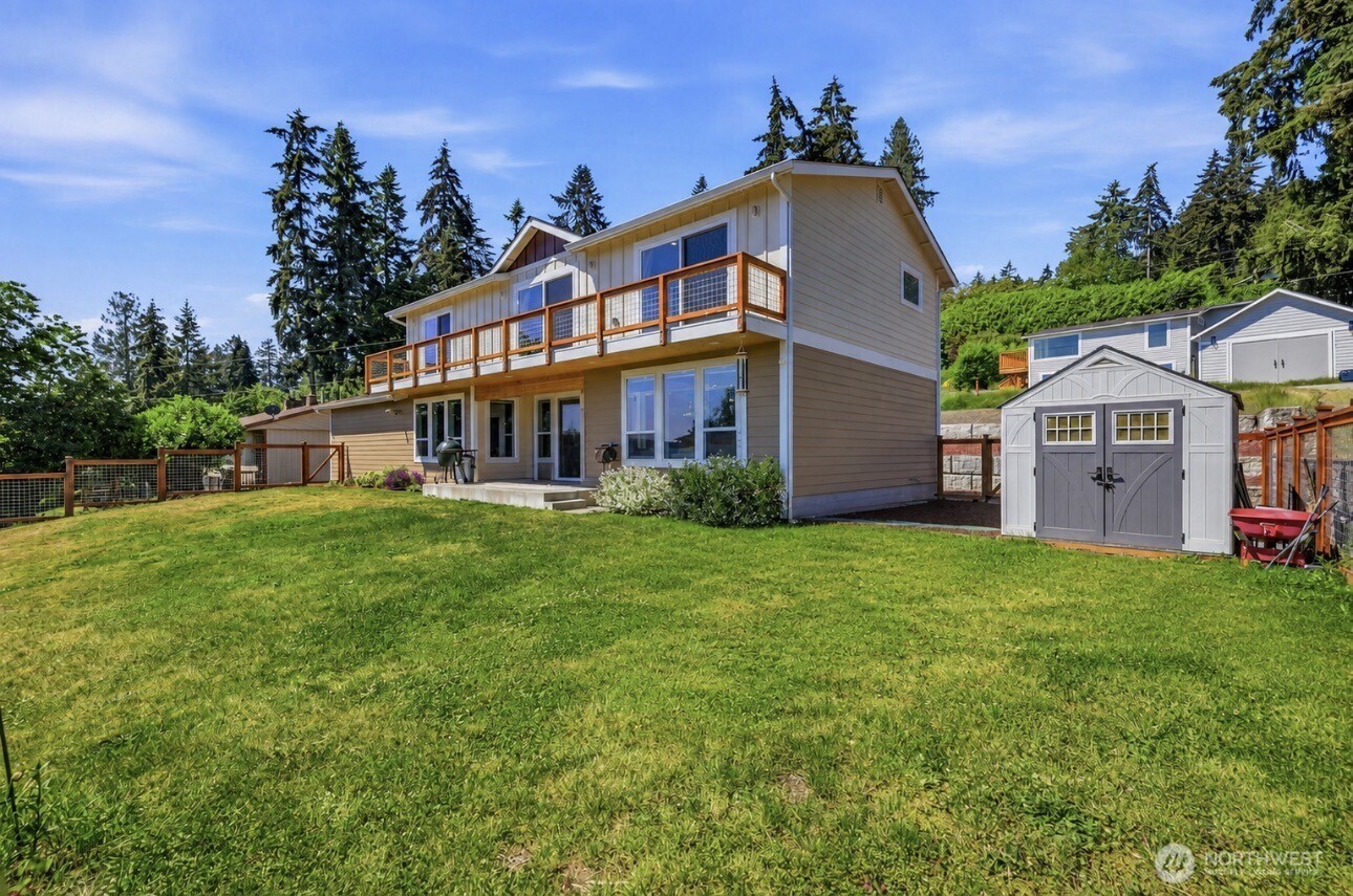 PRICE ADJUSTMENT WITH VA ASSUMABLE LOAN AT 3.75%! Bring your offer! Stunning Illahee 2-story home built in 2021 with water and mountain views! Situated on just under a quarter acre, this 2,343 sq ft home offers an open-concept layout with 3 bedrooms, bonus room, and 2.5 baths. The light-filled main level features remote-controlled blinds, a half bath, a chef’s kitchen with quartz countertops, stainless steel appliances, walk-in pantry, and seamless flow into the dining area and living room with a porcelain tile gas fireplace. Upstairs, retreat to the primary suite featuring a 5-piece ensuite bath with marble countertops. Two additional bedrooms with walk-in closets, a full guest bath, and a versatile bonus room provide flexible living options for an office, playroom, or additional bedroom. Enjoy the full-length upper balcony with slider access from each west-facing bedroom—perfect for morning coffee or evening relaxation. Additional features include ductless mini-splits in every room for year-round comfort, an energy-efficient tankless water heater, and a 2-car attached garage with epoxy flooring. Outdoor amenities include a covered back porch, fully fenced backyard, storage shed, play area with rubber mulch, and terraced front gardens. Conveniently located near Illahee State Park, boat launch, Brownsville Marina, military bases, shopping, dining, and everyday amenities.