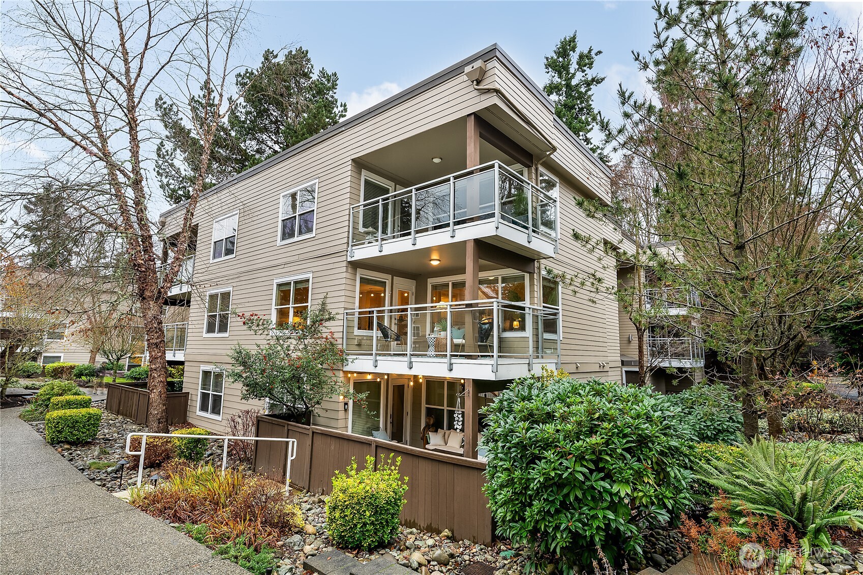 Welcome to Sequoyah - your serene Pacific Northwest retreat. This sunny corner unit overlooks lush grounds, evergreens, and the pool/clubhouse. Light-filled living spaces, social kitchen with newer appliances, spacious living room with cozy fireplace, and formal dining area. Two well-sized bedrooms including a primary suite. Large south facing covered deck - perfect for entertaining year round!  Nearby covered parking, lots of guest parking, and large same-floor secure storage. A thriving, well-kept community with no rental cap and pets ok! Close to downtown Edmonds, the Bowl and great transit options!