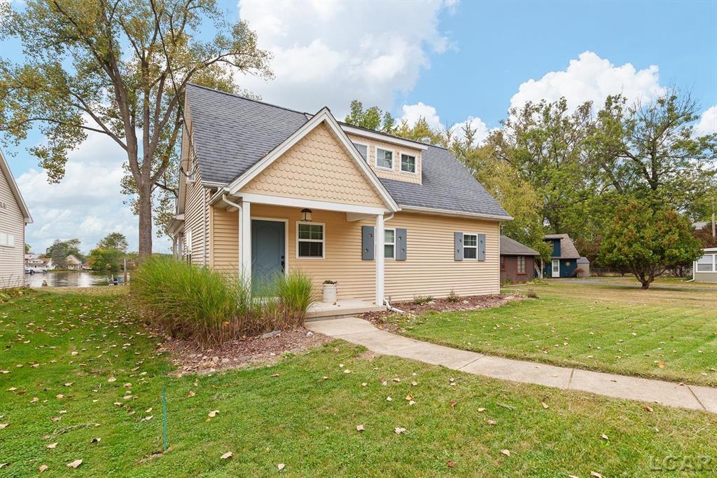Devil's Lake Waterfront Home with 80' of beachfront property. This gorgeous lakefront home features 1700+ sq. ft of living space with 3 BD 1-1/2 BA offered fully furnished is beautifully maintained inside and out.  Hardwood floors throughout with soaring ceilings and walls of windows for natural light.  Open concept kitchen with solid surface countertops and large island seating for gathering.  The dining and living room overlooking beautiful backyard space for all the activities, with no stair steps to the waterfront.  Main floor master bedroom with private patio and views of the lake.  Upstairs features two bedrooms, 1/2 bath and loft area with built in day bed and pull-out queen bed sofa for additional sleeping options.
