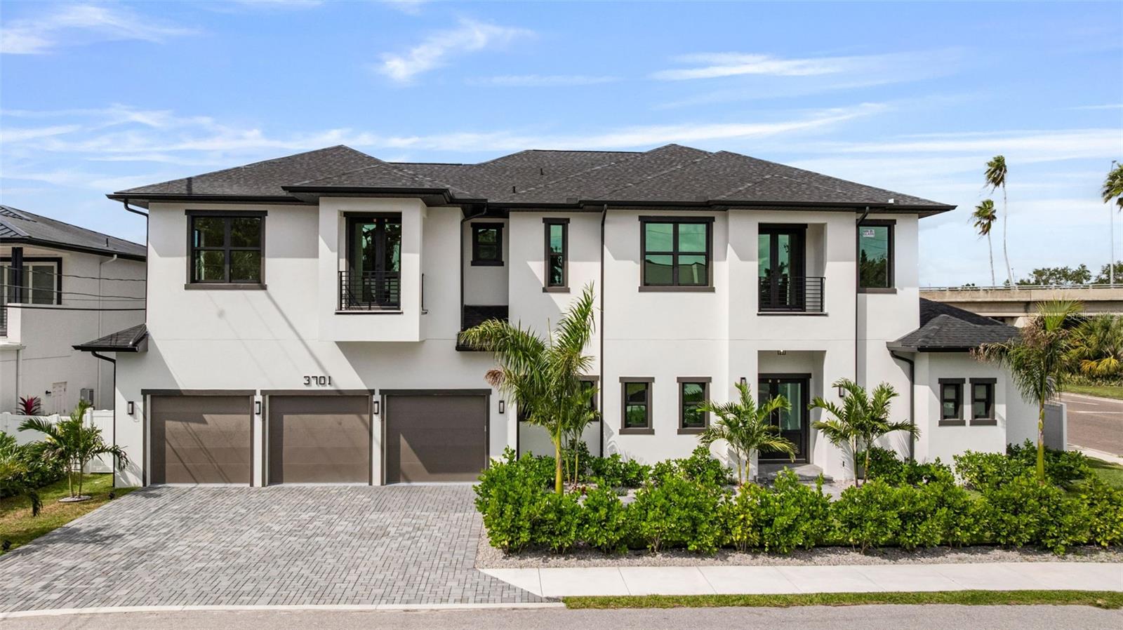 One or more photo(s) has been virtually staged. Brand-new, two-story block constructed modern home with exceptional craftsmanship built by Soho Builders. This home is located just blocks from Bayshore Boulevard in the Bel Mar neighborhood. The property is in an X flood zone and had no flooding during hurricane Helene and Milton. The house has natural gas from the city of Tampa and an extra connection for future use to supply a whole home generator. Upon entering the home you will notice open 12 ft ceilings with 13' tray ceiling details, white oak engineered hardwood as well as high-end impact rated windows and smooth drywall finish throughout. The first floor showcases an elegant glass enclosed 120 bottle wine room, and the kitchen, with floor to ceiling custom cabinetry, quartz countertops, walk-in pantry, all high end appliances such as a Sub-Zero KitchenAid Refrigerator, Kucht 1200 CFM restaurant grade exhaust hood, Thor beverage cooler, Thor nugget ice maker with built in water filter, KitchenAide dishwasher, KitchenAide 48” Gas Range, KitchenAide built-in double ovens and KitchenAide dual function microwave/air fryer. Just off of the kitchen is the breakfast bar and dining area with a built-in Bosch wifi-enabled coffee maker and wet bar. Additional features on the first floor include the laundry room, a mudroom, outdoor kitchen with grill, full guest bathroom, sauna, and the luxurious primary suite with an office/study just off of the bedroom. The second floor features a loft with wet bar and Thor beverage cooler, second laundry room, media room and additional bedrooms each with ensuites and access to one of the four balconies. Additional upgrades include Dual (2) Tesla/EV chargers with 24' charging cables in the garage, epoxy coated garage floor, enhanced landscaping package, sprinkler system, pre wiring for security cameras, vinyl fence, outdoor shower, and indoor/outdoor speakers.