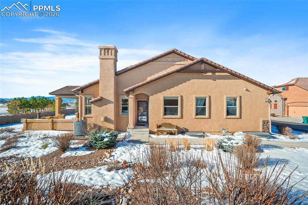 Discover the ease and comfort of main level living in this beautifully maintained patio home, perfectly positioned within the highly sought-after Flying Horse community. Designed with both style and livability in mind, the home offers an inviting layout that feels warm, open, and effortlessly functional.The kitchen is a true gathering space with rich cabinetry, granite countertops, stainless steel appliances, and a generous island that flows seamlessly into the living area. Hardwood floors, soft natural light, and a stunning stone-accented fireplace create an atmosphere that feels refined yet relaxed.The primary suite is a calm retreat, featuring dual vanities, a frameless glass shower, and a spacious walk-in closet. A second bedroom on the main level provides flexibility for guests, a home office, or hobby space. The finished lower level adds even more room to spread out, offering a cozy family room anchored by a second fireplace, two additional bedrooms, a full bath, and abundant storage, perfect for hosting, movie nights, or simply unwinding. Step outside to the covered patio, complete with remote-controlled shades, and take in beautiful views of Pikes Peak. Whether starting your day with coffee or winding down at sunset, this outdoor space invites you to slow down and enjoy the moment. Located in the heart of Flying Horse and just minutes from I-25, the Air Force Academy, and the new King Soopers Marketplace, this home offers convenient access to dining, shopping, and local favorites while maintaining a peaceful, resort-style atmosphere. The HOA provides exterior maintenance and landscaping, making this a true lock-and-leave lifestyle. Flying Horse living offers access to golf, dining, fitness, pools, spa services, tennis, and miles of trails within one of Colorado Springs’ most desirable country club communities. Club memberships are available separately through The Club at Flying Horse, allowing you to enjoy the amenities at your own pace.