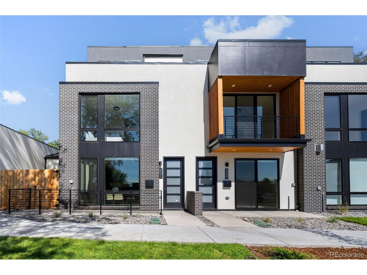 Modern new construction in Denver's sought-after West Colfax neighborhood, featuring a rooftop deck with sweeping city and mountain views, private fenced patio, attached two-car tandem garage, and no HOA. Ideally located near Sloan's Lake and convenient light rail transportation, this thoughtfully designed home offers stylish finishes, flexible living spaces, and low-maintenance indoor-outdoor living. The main level features an open-concept layout with a beautifully appointed kitchen, high-end appliances, dedicated dining area, and spacious living room with sleek fireplace. Large windows fill the home with natural light and showcase the contemporary finishes throughout. Upstairs, two generously sized bedrooms each feature a private en suite bathroom. The third level offers an additional bedroom and full bath, plus a versatile bonus space with direct access to the rooftop deck. Enjoy panoramic city and mountain views from this elevated outdoor retreat-perfect for morning coffee, entertaining, or relaxing at the end of the day. With no HOA, new construction, and a prime West Colfax location, this home delivers the perfect combination of modern design, functionality, and Denver lifestyle.