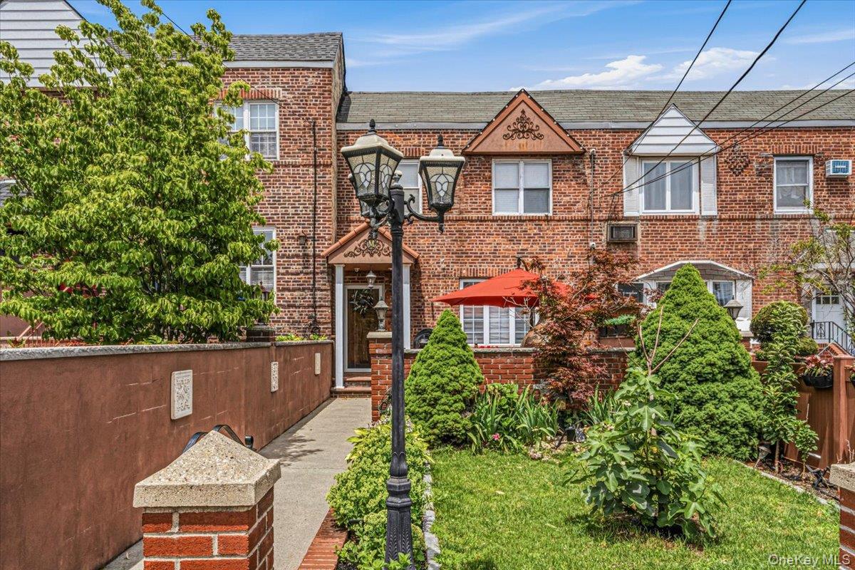 Offering a rare combination of outdoor living, parking, and functional interior space, this brick single-family home is a standout opportunity in Astoria.Set behind a spacious front yard with established garden areas, the property welcomes you with a brick-paved patio featuring a gas-fired pizza oven—an ideal setting for outdoor dining, entertaining, or relaxing at home. Inside, hardwood floors run throughout the main level, which includes a comfortable living room, formal dining room, and kitchen with stainless steel appliances. The dining room opens directly to a large patio, creating an easy connection between indoor and outdoor living.The second floor features three bedrooms and a beautifully finished tumbled marble bathroom complete with a Jacuzzi tub. Radiator heat and three mini-split air conditioning units provide year-round comfort.The full finished basement expands the home's versatility with additional living space, a full bathroom, and walk-out access to the backyard.The backyard currently features an Intex above-ground pool with filtration system. The pool occupies the garage access area and may be removed to restore full use of the one-car garage and parking space. Additional highlights include driveway access via a shared driveway and the flexibility to tailor the outdoor space to your needs.A thoughtfully maintained Astoria home offering a unique combination of indoor comfort, outdoor enjoyment, and practical amenities rarely found together.*Some photos are virtually edited/staged.
