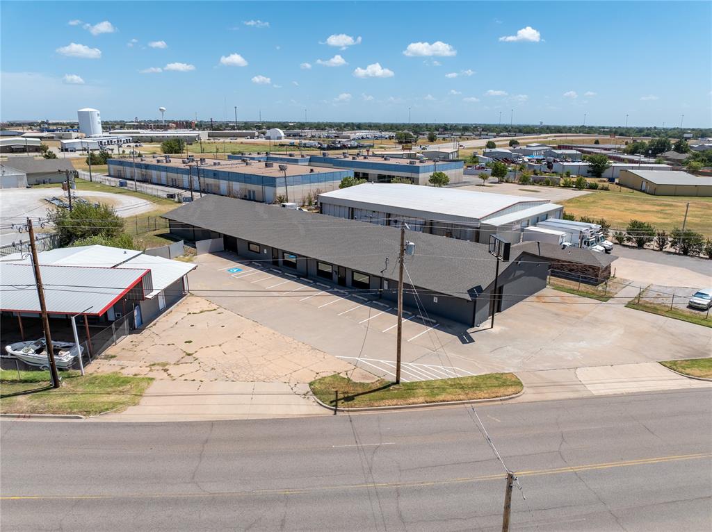 What a unique opportunity for a building so with many possibilities!  There are two exterior door entrances which would allow for this building to be used as two distinct businesses.  Where else will you find a HUGE shop area with two overhead doors that is CLIMATE CONTROLLED?!  Amenities include 4 handicap accessible bathrooms, one with full shower, there are 4 HVAC units, 2 large shop areas with overhead doors, 10 parking spaces, 1 handicap parking space, option for 5 private offices (3545 sf), storage areas, and one shop area with floor drain.  One hallway connects both sides and could easily accommodate a wall to separate businesses.  Run your business on one side and rent the other!  Great investment opportunity!