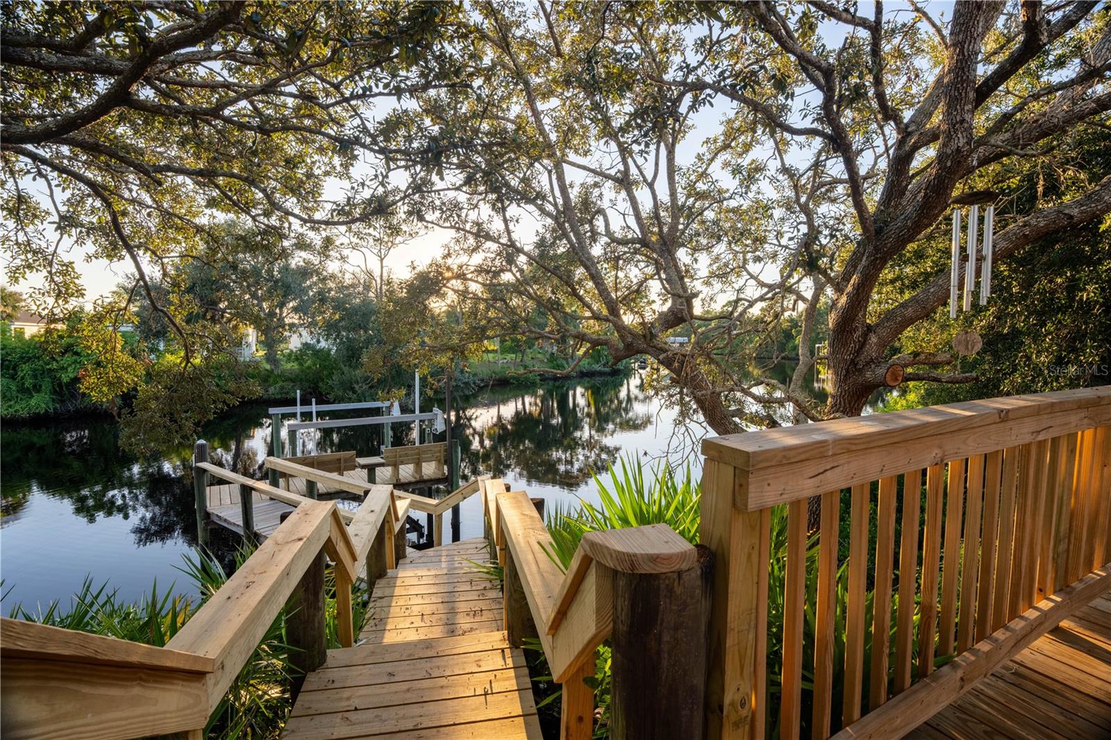 Under contract-accepting backup offers. TOTALLY UPDATED POOL HOME WITH BOAT LIFT AND GULF ACCESS. This is your chance to live in a great home on the water without being in a flood zone. This is X flood zone. No flood insurance required. This 3 bedroom 2 bath home has all new LVP flooring, kitchen, bathrooms, appliances, fixtures, trim, paint, outdoor kitchen and paver driveway. All cabinetry is dove tail with soft close feature, and all counters are quartz. The floor plan is spacious, bright and open with high ceilings, huge windows, and a wood burning fireplace that is shared between the family room and the 3rd bedroom or den. The open kitchen is amazing and overlooks the family room. The living room, family room and primary bedroom all have large windows and sliders leading to the screened and covered lanai and pool. The outdoor living space is beautiful and tranquil with an awesome view of your shade trees, dock and river. Enjoy watching the visiting Manatee, jumping Mullet, and rolling Tarpon from your updated dock. After boating for the day, you can lift your boat out of the water, jump in the pool, and cook the catch of the day at your amazing outdoor kitchen. Then have a cocktail and watch a beautiful sunset from your shaded deck. River Landings also has a community pool and dock, and is only a few miles to I-75. Low HOA and no CDD fee. This location is convenient to Lakewood Ranch, UTC Mall, Sarasota, Bradenton, restaurants, shopping, and golf. This home is great for entertaining and enjoying the Florida lifestyle.
