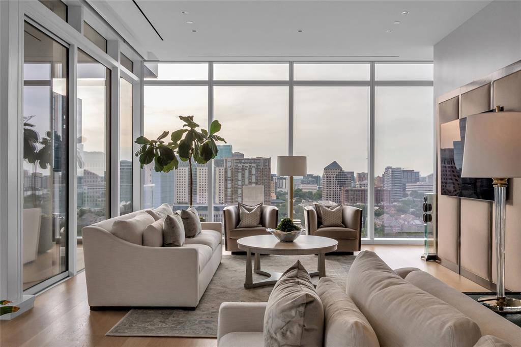 With Dallas skyline views from the 14th floor of the prestigious Hall Arts Residences in the heart of the Dallas Arts District, Unit 1402 offers elevated luxury living with 3 bedrooms, 3.1 baths, and 3,677 square feet of impeccably designed interiors. Built in 2020, this sophisticated half floor residence showcases exceptional craftsmanship and designer finishes throughout, including embossed leather walls, luxe wallpaper accents, Ornare custom closet, mirrored storage cabinetry, and expansive floor-to-ceiling windows framing the best most immersive views of Dallas, including the AT&T Performing Arts Center and Winspear Opera House. The spacious layout features a private alcove, abundant storage throughout, AV audio systems and electric window shades  already integrated, as well as a chef’s kitchen outfitted with Miele refrigeration, wine storage, and premium Gaggenau appliances including a warming drawer, oven, and microwave.The serene primary suite offers plush carpeting, generous custom storage with built-in dividers and drawers, and a spa-inspired bath with refined finishes. It is also tucked away from the secondary bedrooms. The secondary bedrooms each feature en-suite baths with sleek stand-up showers. Residents enjoy access to Hall Arts Hotel-level amenities including concierge services, resort-style pool and hot tub, putting green, fitness center, pet spa and dog wash station, wine room, massage treatment room, a catering kitchen, boardroom, outdoor grilling areas, game room, and more! This residence is move-in ready and available to be purchased furnished, it delivers an unmatched lock-and-leave lifestyle in one of Dallas’ most exclusive luxury towers and in the Arts District with great walkability to some of the best restaurants and culture.