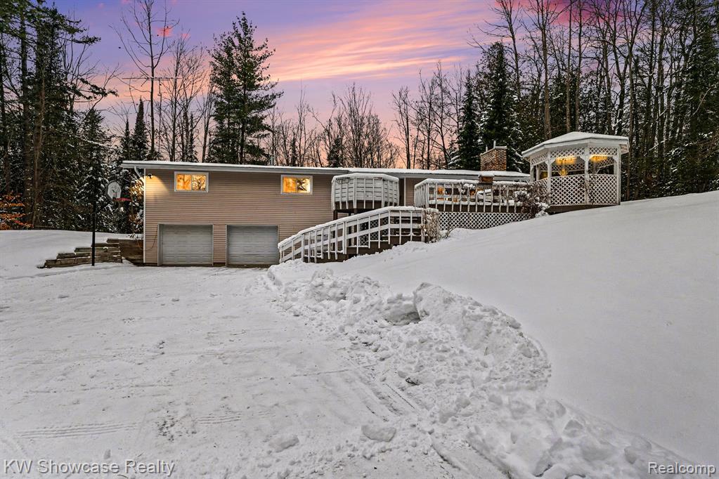 Location! Location! Location!Private setting, close to town with beautiful views!Welcome to 1951Kneeland Rd. Fairview, MI This is a 3-bedroom 3-bath home with many updates. Primary Bedroom with en-suite. The kitchen features custom cabinets, new bamboo flooring, and appliances, along with a large island, making food prep and entertaining a breeze. The living room is large and open with a fireplace to make it extra cozy. A walkout basement leads into your two-car garage to keep you free from the elements. The  finished basement provides additional living space along with a ton of storage. Outbuildings include a 16x24 shed, an 8x16 Garden shed, and an 8x14 Treehouse/Blind. Offering versatility for hobbies, storage, or outdoor equipment.