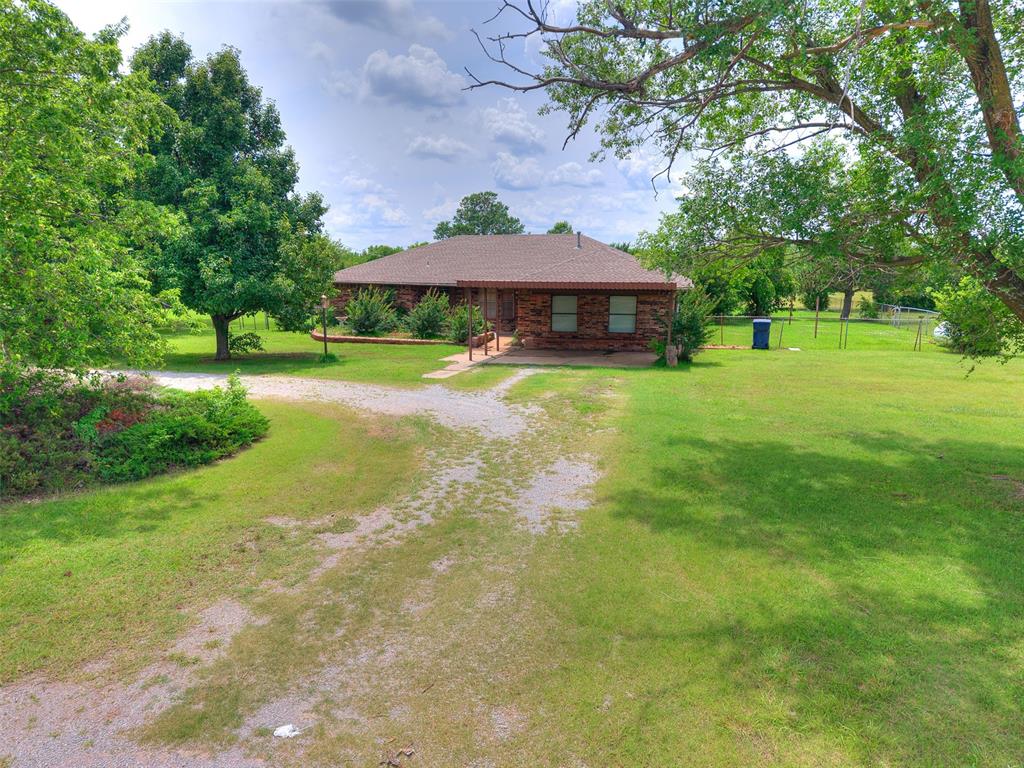 Looking for a home & 5 acres in the Moore school district? Come make this one your own! This home features good size living room w/fireplace. There is additional living space/den area open to the main living room & also in converted garage. Kitchen features a breakfast bar, possible coffee bar area & pantry. The primary bedroom has a private bathroom w/tile shower & walk-in closet. The property has a storage shed, a lean to & pond in the corner.  With the home setting on a corner of this 5 acre parcel, there is plenty of room for a pool, shop, barn, ... it's like having a blank canvas.