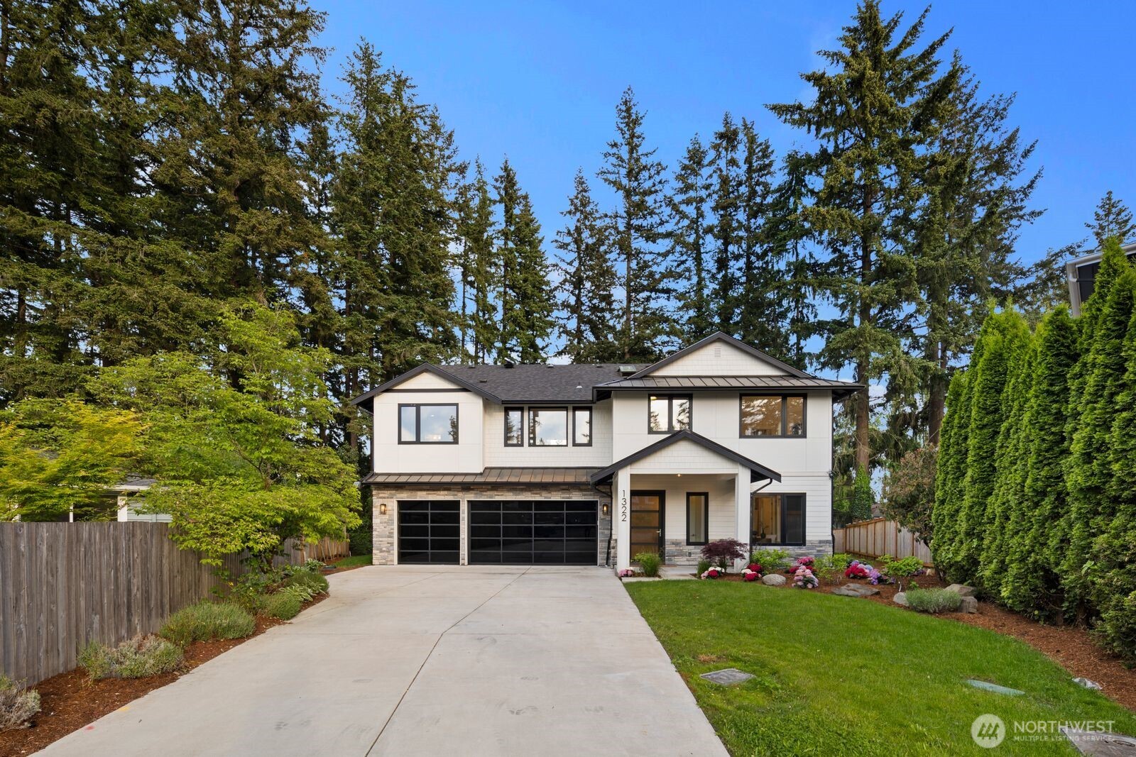 Some homes are built to a plan. This one was built to a philosophy. Set in one of Northeast Bellevue's most established and sought-after neighborhoods — minutes from Microsoft, downtown Bellevue, and quick access to both SR-520 and I-405 — this 2025 modern-craftsman reflects a builder obsessed with how a home actually lives: where light lands, how rooms connect, and where a family naturally gathers. Walls of triple-pane glass pull sunlight deep into the great room, where custom accordion doors fold away entirely — dissolving the wall between the vaulted living space and a covered cedar-ceiling patio with stone gas fireplace. Indoor and outdoor become one effortless room. The chef's kitchen is the heart: Thermador 36" fridge and 48" range, dedicated prep kitchen, herringbone backsplash, and an oversized quartz island with bar seating built for gathering. A main-floor office/5th bedroom with full bath offers true flexibility, while the mudroom-laundry keeps daily life seamless. Upstairs, a serene primary suite with linear gas fireplace opens to a spa bath with heated floors, floating tub, dual vanity with makeup table, and his-and-hers closets. A wet bar lounge and skylights add light and warmth throughout. High-efficiency systems, hybrid water heater, sprinklers, 3-car garage. Award-winning Bellevue Schools — Sherwood Forest Elementary, Highland Middle, Interlake High. Intentional, turnkey, exceptional.
