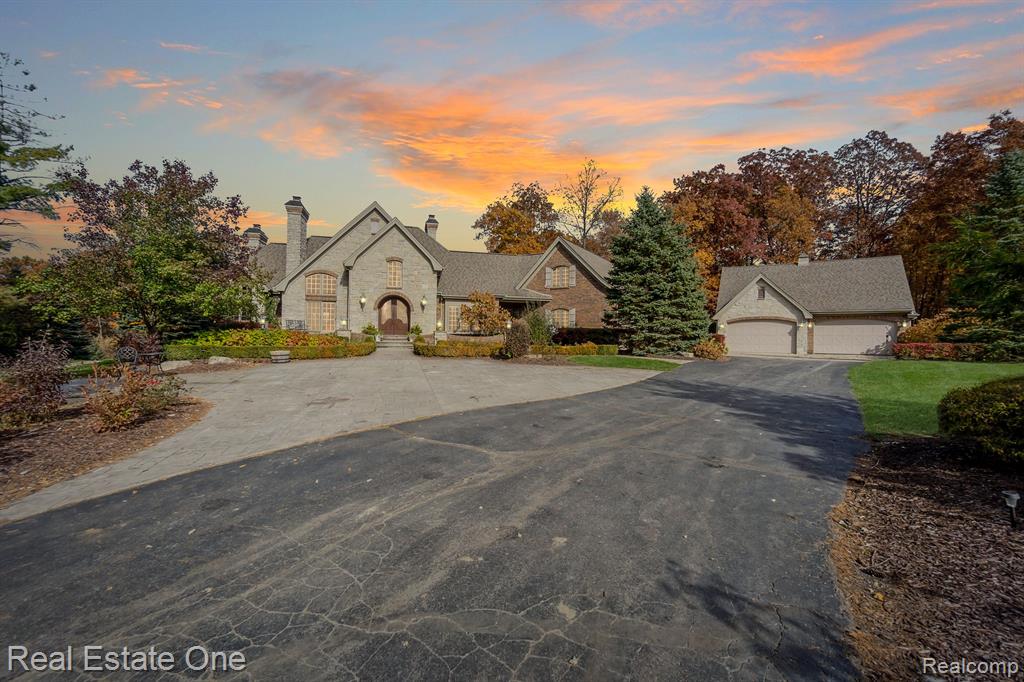 Private Lakefront Luxury on 14 Acres | Resort-Style Living with Every Amenity? 
Step into a world of refined lakefront living with this extraordinary 14-acre Country French estate—a true sanctuary of luxury, seclusion, and unforgettable memories. Tucked behind a private gated drive, this custom brick-and-stone masterpiece offers over 7,000 square feet of exquisite craftsmanship designed for both relaxation and grand entertaining. Inside, discover a chef’s dream kitchen featuring granite countertops, Brazilian cherry floors, a wet bar, 3 Thermador ovens, and a 6-burner stove. The main-floor primary suite is pure indulgence with heated floors, a hydro jet tub, and a custom walk-in closet. The two-story hearth room stuns with a dual-sided fireplace and flows into a four-season sunroom offering panoramic lake views and heated floors. A dedicated home office with a fireplace and private entrance makes working from home serene and seamless. The finished walkout lower level is built for entertaining—complete with a full bar, home theater, game room, cedar sauna, and a full and half bath. Outdoors, enjoy your private paradise: a heated saltwater pool and spa with a cabana, a lakeside gazebo with custom stone fireplace, electricity, bar fridge, and plenty of storage for outdoor entertaining. The kids' imagination will take them anywhere in their storybook cedar loft playhouse, complete with electricity, a fireplace, and an intercom system. Your private lake is ideal for swimming, fishing, and kayaking. A whole-house generator adds peace of mind, while an additional heated detached garage offers flexible storage or workshop space with a loft. Whether you're seeking a year-round retreat, multigenerational homestead, or a luxury family compound, this rare estate has it all—privacy, elegance, and adventure, all on one pristine waterfront setting. Now including the 8.81 adjoining acres. The property ID# must be included on the PA. Property ID# 01002700175