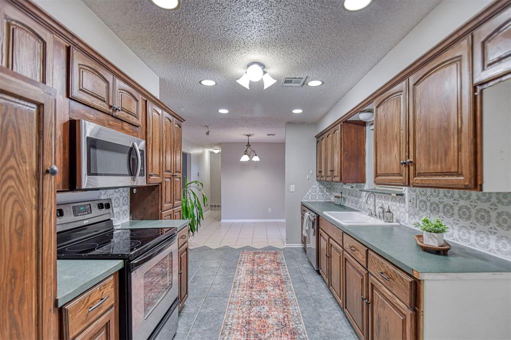There is a lot to love about this 3-bedroom, 2-bath home! The 1,310-square-foot layout offers a roomy kitchen with plenty of cabinet space and a gas hookup for those who prefer to cook with gas. The dining area has floor-to-ceiling built-ins and opens to the backyard through sliding glass doors. The primary bathroom features a walk-in shower with a sliding glass door, and the secondary bedrooms are both generously sized. The guest bathroom includes a bidet, and the laundry room has a door leading directly to the backyard. Outside, you’ll find a large covered patio, a spacious backyard, a storage building, and an above-ground storm shelter. The 2-car garage is complemented by a carport that covers the entire driveway, while the covered front porch, full guttering, and additional concrete along the side of the home add to the functionality. With great indoor space and a backyard that offers plenty of room and storage, this home has a lot to offer! Welcome Home!
