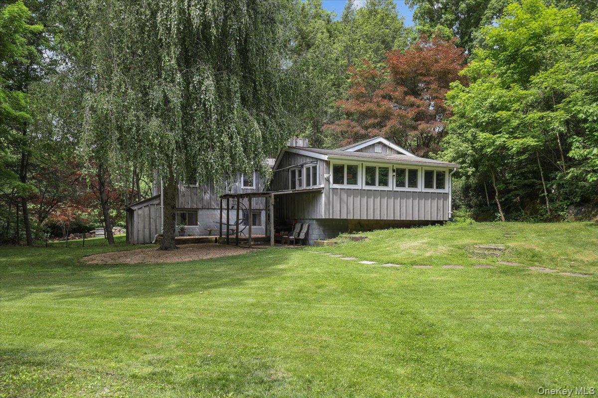 Lake Kitchawan and Award-Winning Katonah-Lewisboro Schools. Tucked away on an idyllic, level piece of property framed by mature trees, this thoughtfully updated 2-bedroom with office, 1.5-bath home offers a rare blend of privacy, comfort and refined simplicity. The living room features a wood-burning fireplace and serves as a central gathering spot flowing seamlessly into a well-appointed eat-in kitchen.  Kitchen fully renovated in 2017 and features lots of natural light, generous counter space and abundant storage—ideal for both everyday living and relaxed entertaining.  The lower level is partially finished and offers quiet space set apart from the main living space, creating an ideal environment for working from home or other focused pursuits. Lower level also includes laundry, a dedicated fitness area, storage, and utilities—providing exceptional flexibility and function.  Enjoy living in Lewisboro within the welcoming Lake Kitchawan community with coveted lake rights and all the natural beauty of this special setting. This home captures the ease and rhythm of a relaxed lifestyle, a perfect opportunity for year-round living or a peaceful weekend escape.
