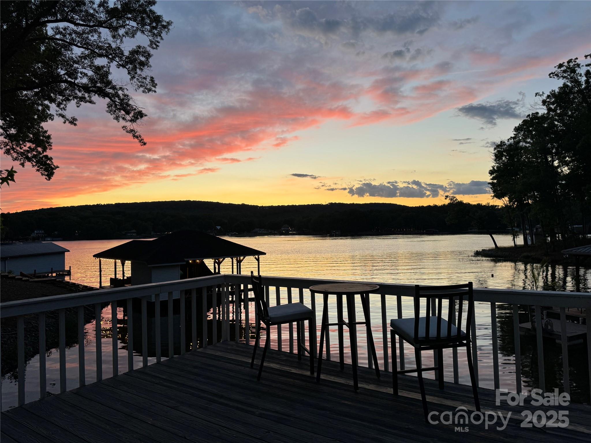Enchanting 4BR/3BA Cape Cod waterfront home in the gated Woodrun community on Lake Tillery is a private retreat for nature lovers! Surrounded by mature trees & landscaping, the privacy you feel here is an uncommon treasure at the lake. The home features bamboo flooring throughout with a bright, serene interior. Enjoy the wraparound porch & functional outdoor spaces perfect for relaxing or hosting. With 2 bedrooms on main level + 2 upstairs, you can choose either level for the primary bedroom. A favorite feature of the property is the ability to find shade any time of day whether you are at the dock or enjoying an outdoor space at the house. Walk-out basement offers a wet bar, living and recreation area. Watch birds & wildlife, take in sunsets with main channel views of Lake Tillery. Woodrun has so much to offer with amenities including: boat ramp, outdoor community pool, lake side clubhouse, tennis courts, basketball court, & trails. Near Morrow Mountain & Uwharrie National Forest.