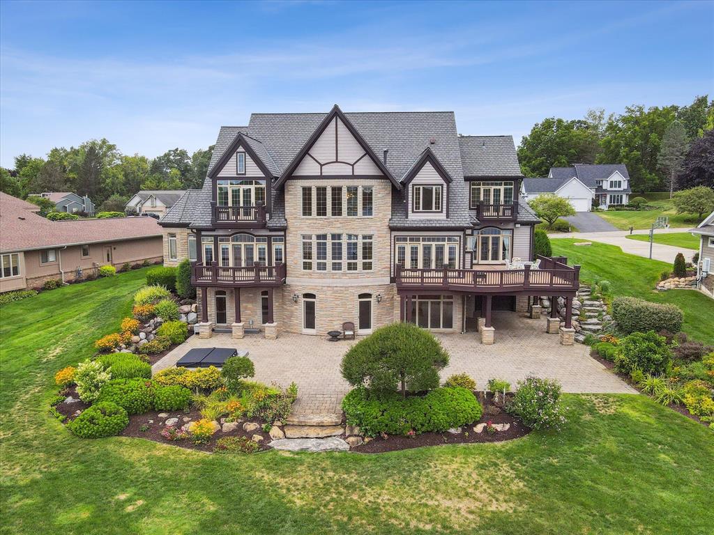 Discover this extraordinary lakefront estate, offering 150 feet of prime all-sports lake frontage, on the shores of Silver Lake in Fenton, MI.   Perfectly positioned for breathtaking views and year-round recreation, this property blends luxury with elegance with over 7,000 square feet of exquisite living space. Step inside to soaring ceilings, expansive windows, and the view of the water from nearly every room. Entertain with ease in the chef's kitchen equipped with gourmet appliances and custom finishes.  Then retreat to the private primary suite with its spa-inspired amenities. The lower level is an entertainer's dream, offering a catering kitchen, wet bar, wine fridge, pool table, and walk out basement with only a few short steps to the in-ground spa. Outside you discover expansive decks, sunlit patios, and a private dock. Whether boating or simply unwinding by the fire, every moment is elevated by the beauty of Silver Lake.  This is more than a home, it luxury lakefront living.