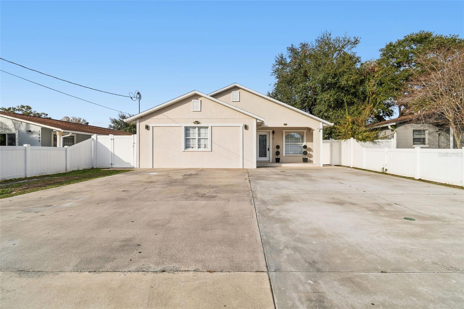 Welcome to this unique and versatile single-family home with NO HOA or CDD fees, located in the heart of Tampa! Built in 2012 with solid block construction, this beautifully upgraded property offers 3 spacious bedrooms and 3 full bathrooms, including an exclusive layout with three master bedrooms and connected living spaces. Two of these suites feature independent entrances, making them ideal for extended family, guests, or rental income opportunities—one suite is a garage conversion, and another includes its own kitchenette. Inside, you'll find a chef's dream kitchen with solid wood cabinets, stunning granite countertops, and easy-to-maintain tile flooring. Bathrooms have been updated, and newer windows add comfort and style. Outside, enjoy a maintenance-free, fully fenced yard with vinyl fencing and a beautiful concrete patio, perfect for entertaining. There's even a cozy covered porch for relaxing in the shade. Recent upgrades include a NEW AC installed in 2023 and a newer roof. Conveniently located just minutes from Raymond James Stadium, top restaurants, International Plaza, and major shopping centers. NO FLOOD ZONE!