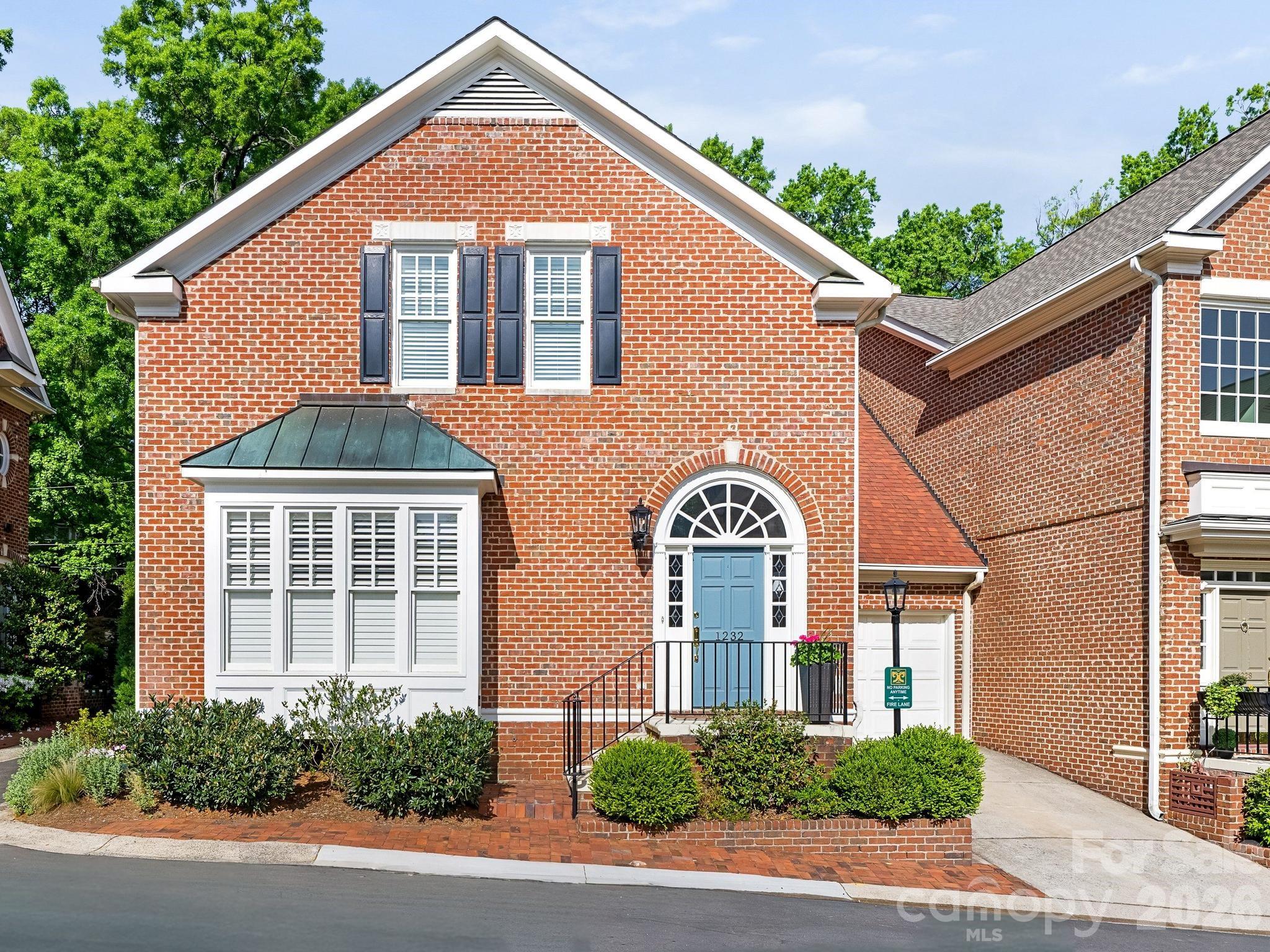 Fantastic opportunity to own a beautiful end-unit townhome in the heart of Dilworth. It features a RARE main-level primary suite (one of only three units with primaries on the main level in the whole community). This light-filled home delights with double-height ceilings in the foyer and living room. The stylish kitchen offers an oversized eat-in island, quartz countertops and Thermador appliances. The spacious primary includes a custom designed walk-in closet and a well-appointed bath with dual vanities, jet tub, and a separate shower. Upstairs are two bedrooms, one with a walk-in closet, and a full bath in the hall. Two walk-in attics offer countless expansion opportunities. Designed for comfortable living and entertaining, the open and airy floor plan is enhanced with 10' ceilings, heavy moldings, a gas fireplace, custom built-ins and a wet bar. Ideally positioned on what is arguably the most desirable block inside the townhome community, the beautifully landscaped courtyard is surrounded by mature oak trees and exits onto Lexington Ave. -- offering both charm and maximum convenience. Don't miss this move-in ready gem!