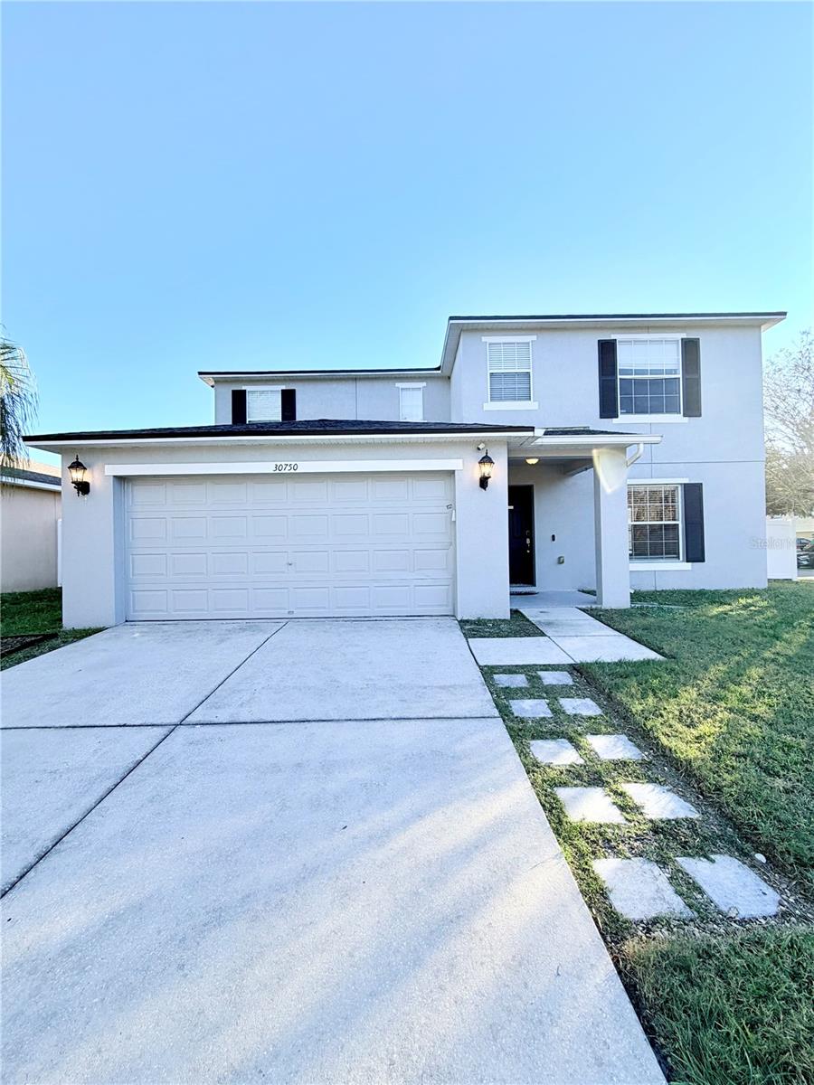 Nestled on a desirable corner lot in the sought-after Ashley Pines community, this 4-bedroom, 3.5-bath home (plus loft and flex space) offers generous living and style in the heart of Wesley Chapel, FL. With approximately 2,759 sq ft under roof and over 7,800 sq ft of lot space, this home blends comfort, functionality, and curb appeal.  Situated in the family-friendly and rapidly growing Wesley Chapel area, residents enjoy access to a mix of modern conveniences and lifestyle amenities. From shopping and dining at centers like The Shops at Wiregrass to outdoor recreation, parks, and quality schools — this home offers the best of suburban Florida living.Low HOA with no CDD fees, adding to the home’s cost-effectiveness and accessibility.Inviting covered front porch leads to a bright and open floor plan — ideal for welcoming guests or relaxing evenings in. Stylish touches throughout: laminate flooring, crown molding, wainscoting, and a standout faux-brick accent wall add character and warmth. Expansive front family room flows seamlessly into the kitchen, dining, and living areas — perfect for entertaining or family time. Kitchen designed for both function and fun: stainless-steel appliances, granite countertops, a large island with breakfast bar, and ample cabinetry/pantry space. The owner’s suite serves as a private retreat — dual vanities, built-in vanity, walk-in glass shower with rain-shower heads. Upstairs you’ll find a bonus loft/bonus room — great as an extra living area, playroom, or home office — plus a guest bedroom with its own full bath.  Fully fenced backyard — Recent updates include a new roof (2021), smart-home features (coded locks, video doorbell, exterior security cameras, NEST thermostat), under-stairs storage, and a garage door opener for convenience. Low HOA with no CDD fees, adding to the home’s cost-effectiveness and accessibility.  ?