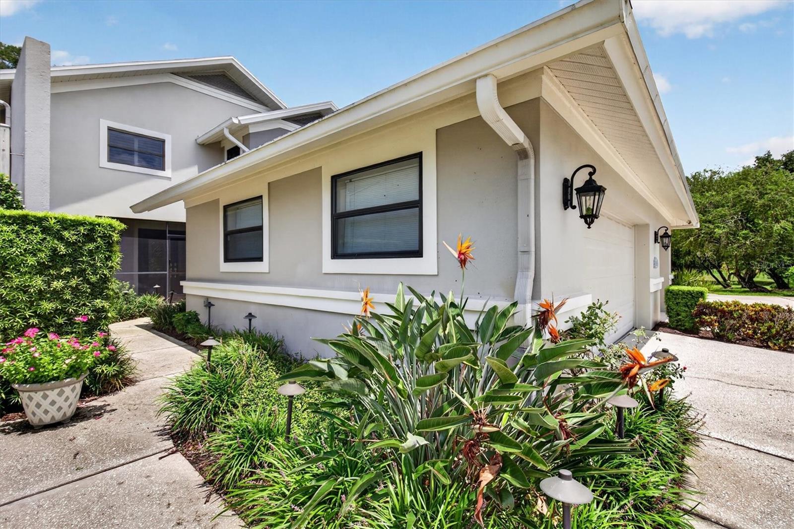 Discover this beautifully updated 4-bedroom, 3-bath villa offering 2,727 sq ft of light-filled living in the prestigious 24-hour guard-gated Cypress Run community of Tarpon Springs.  This two-story villa features soaring ceilings, a remodeled kitchen with updated wood cabinetry and granite counters, fresh interior paint, and modern lighting throughout—including recessed lights, new fixtures in the kitchen and dining areas, and a new ceiling fan in the primary suite.Enjoy flexible living with separate spaces perfect for families/entertaining, an inviting dining area, a first-floor full bath (converted for convenience), and exceptional storage including a rare full-length cedar-lined walk-in closet. The primary suite opens to a private balcony with panoramic views—ideal for morning coffee. Outside, relax in the screened-in BBQ area overlooking a private wooded setting of mature trees and tranquil conservation land, frequently visited by deer, baby bunnies, and other wildlife.Major 2022 upgrades deliver peace of mind: new roof, over $13,000 air conditioning system, garage door opener (myQ), and water softener. Additional highlights include keyless digital entry, wired security system, new landscape lighting, and a newly enclosed climate-controlled third garage bay suitable for a Golf Cart with new electrical—perfect also as a gym, workshop, or extra storage. HOA covers pool, grounds, trash/recycling, some exterior maintenance, security guard/gated, lush community landscaping and private roads.Move-in ready with modern updates, abundant storage, and serene nature views in one of Tarpon Springs’ most desirable gated communities. Don’t miss this rare opportunity—schedule your private showing today!