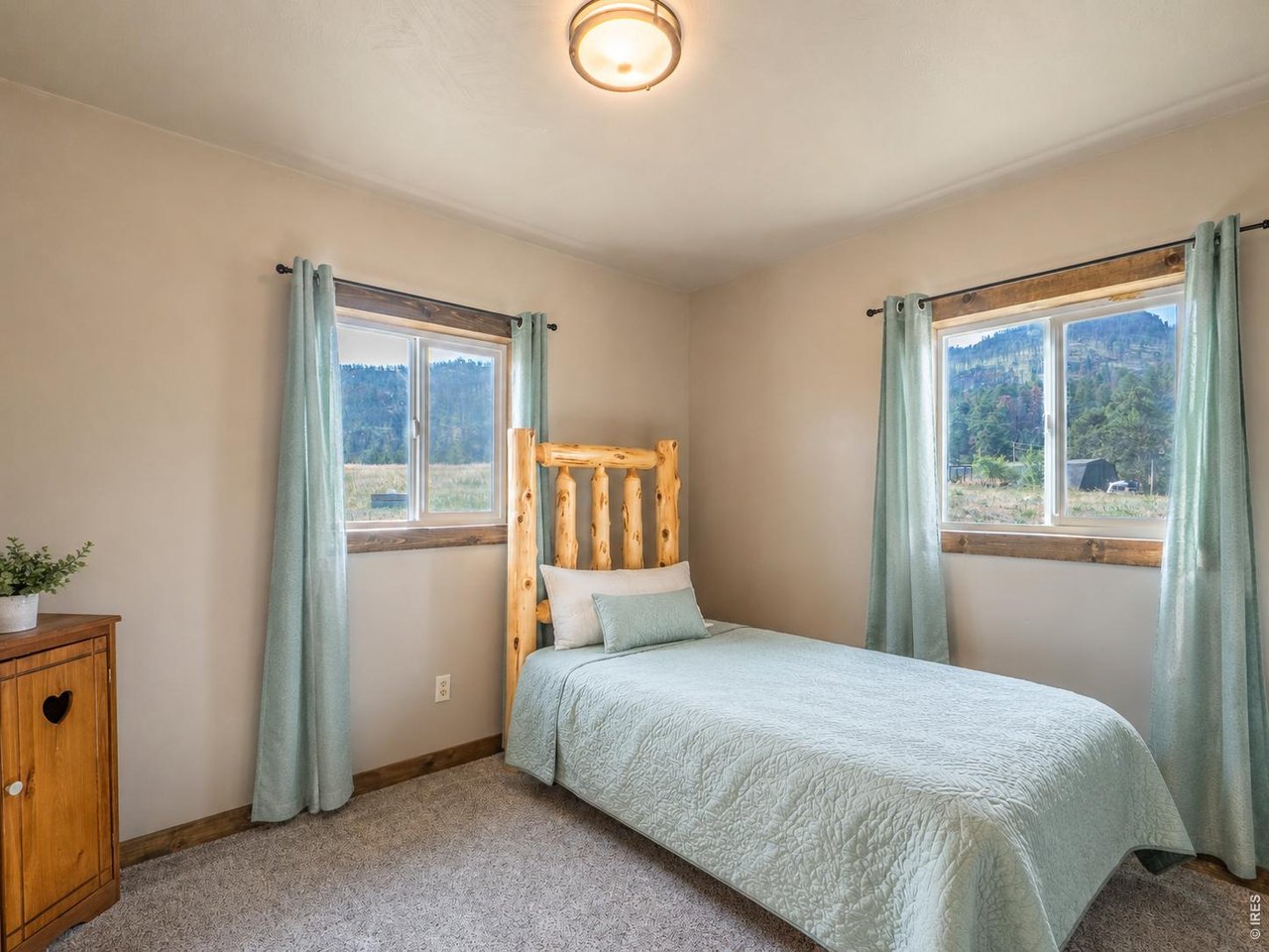 A cute little mountain home with BIG MOUNTAIN VIEWS! Tucked into the valley on Storm Mountain, this move-in-ready 2-bed, 1-bath home features newer flooring, a cute kitchen with newer appliances, and a newer roof. Enjoy breathtaking views from the porch, elk wandering through the yard, and the convenience of Loveland just 25 minutes down the canyon. Sitting on just under an acre with room to grow, this home is a perfect vacation getaway or full-time residence. Centrally located between Estes Park and Loveland, don't miss this Storm Mountain hidden gem for affordable mountain living.
