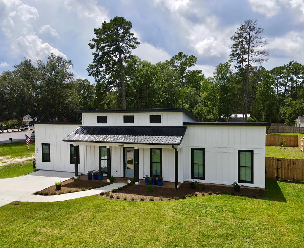 This modern, contemporary two-bedroom, two-bathroom home boasts stained concrete floors, 12-foot tongue-and-groove pine ceilings in the spacious great room, stainless appliances, a built-in microwave drawer, marble countertops, 12ft kitchen  island, and 8-foot doors throughout. All interior and exterior walls are insulated, and the attic is filled with extra-open cell insulated spray foam. Two covered back porches offer a glimpse of the private fenced backyard, which features an inground saltwater splash pool. The low-maintenance hardiboard siding and metal roof provide a pleasant and easy to maintain exterior. A tankless gas  water heater ensures endless hot water, and all amenities are conveniently located within a golf cart's distance to the charming bricks of downtown Thomasville. Security system.