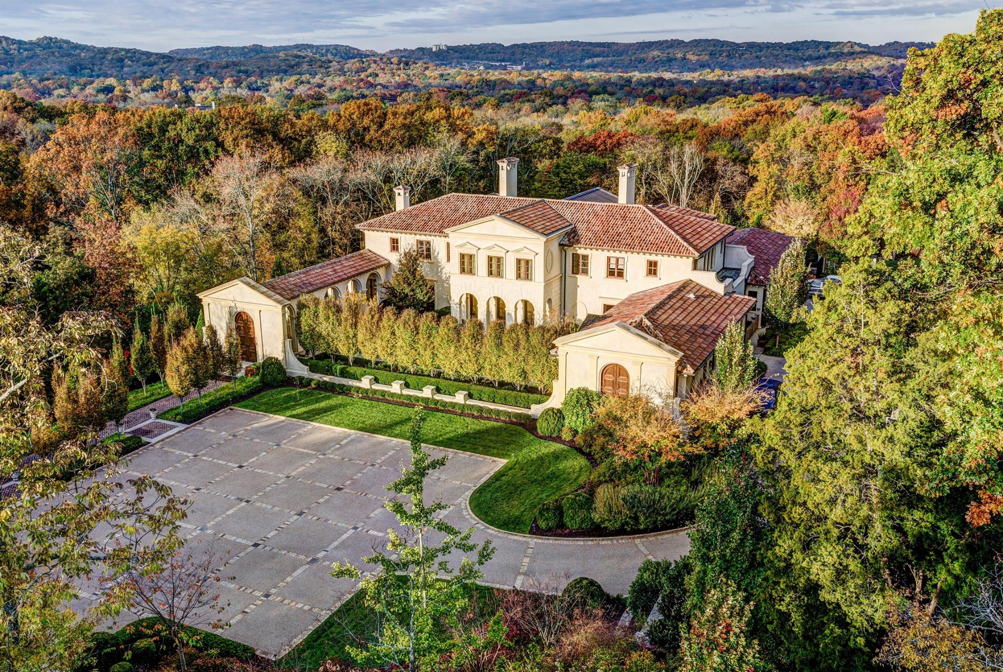 "Bella Vista" a sumptuous property nestled into the rolling hills w/ stunning western views of Nashville is  located on 2+ acres incredibly convenient to shops/schools/medical/fine dining. Exquisite design and features include extraordinary finish quality throughout w/ gorgeous millwork, wide plank walnut flooring, wood beamed ceilings, natural stone countertops, marble walls  & modern high end lighting. Recent complete renovation includes state-of-the-art conveniences(AV/WiFi/Security). The perfect home for an active family with plenty of room for home offices, studios, storage, w/ the added bonuses of an apartment & a 4-car garage. Fabulous blend of old & new, substance & sophistication!