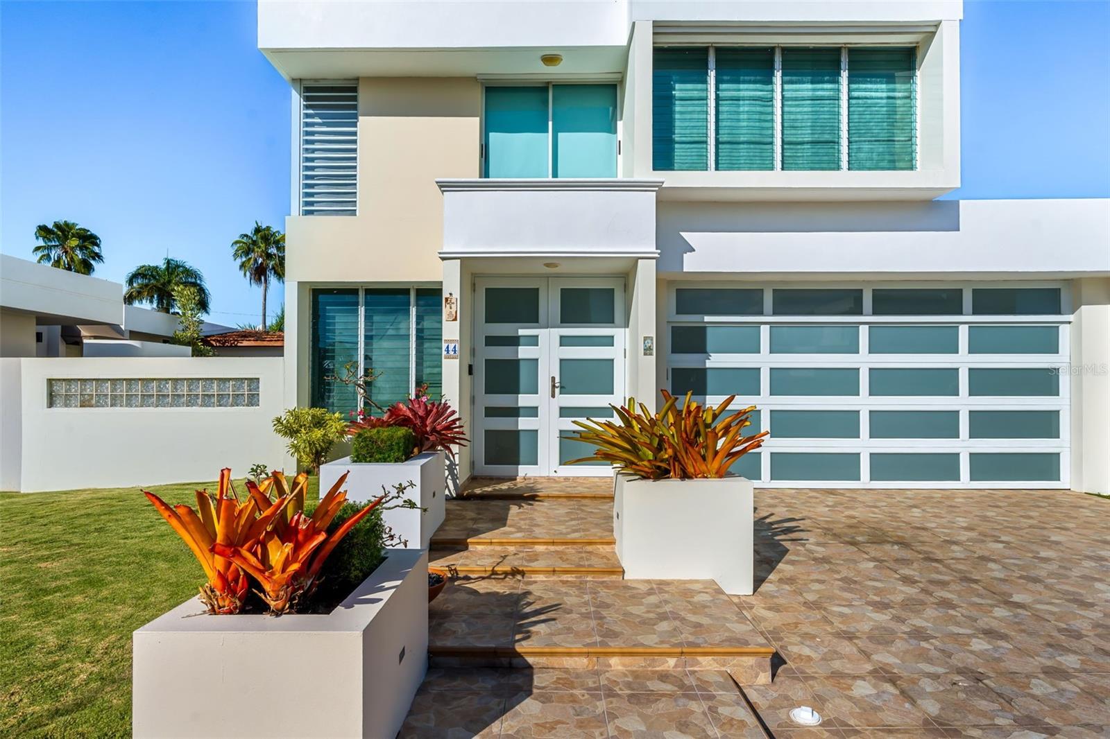 Two-story residence located in Paseo Real, a double-gated community with 24/7 security, ideal for buyers seeking privacy without compromising accessibility.The home offers approximately 2,300 square feet of living space on a 504 m² lot, featuring 4 bedrooms, 2.5 bathrooms, living and dining areas, a family room, a covered terrace, and a dedicated home office ideal for remote work. The layout benefits from excellent natural light and airflow throughout both levels.The kitchen and bathrooms are in good condition and fully functional. The exterior was recently painted, and the property is clean, well maintained, and move-in ready. An added value is the 27 solar panels with two Tesla batteries for greater convenience.Paseo Real offers desirable amenities such as a swimming pool, tennis and basketball courts, gazebo, and playground. The community provides a quiet and secure environment while remaining conveniently close to shopping, hospitals, dining, and PR-22 highway access. Annual HOA: $2,300.