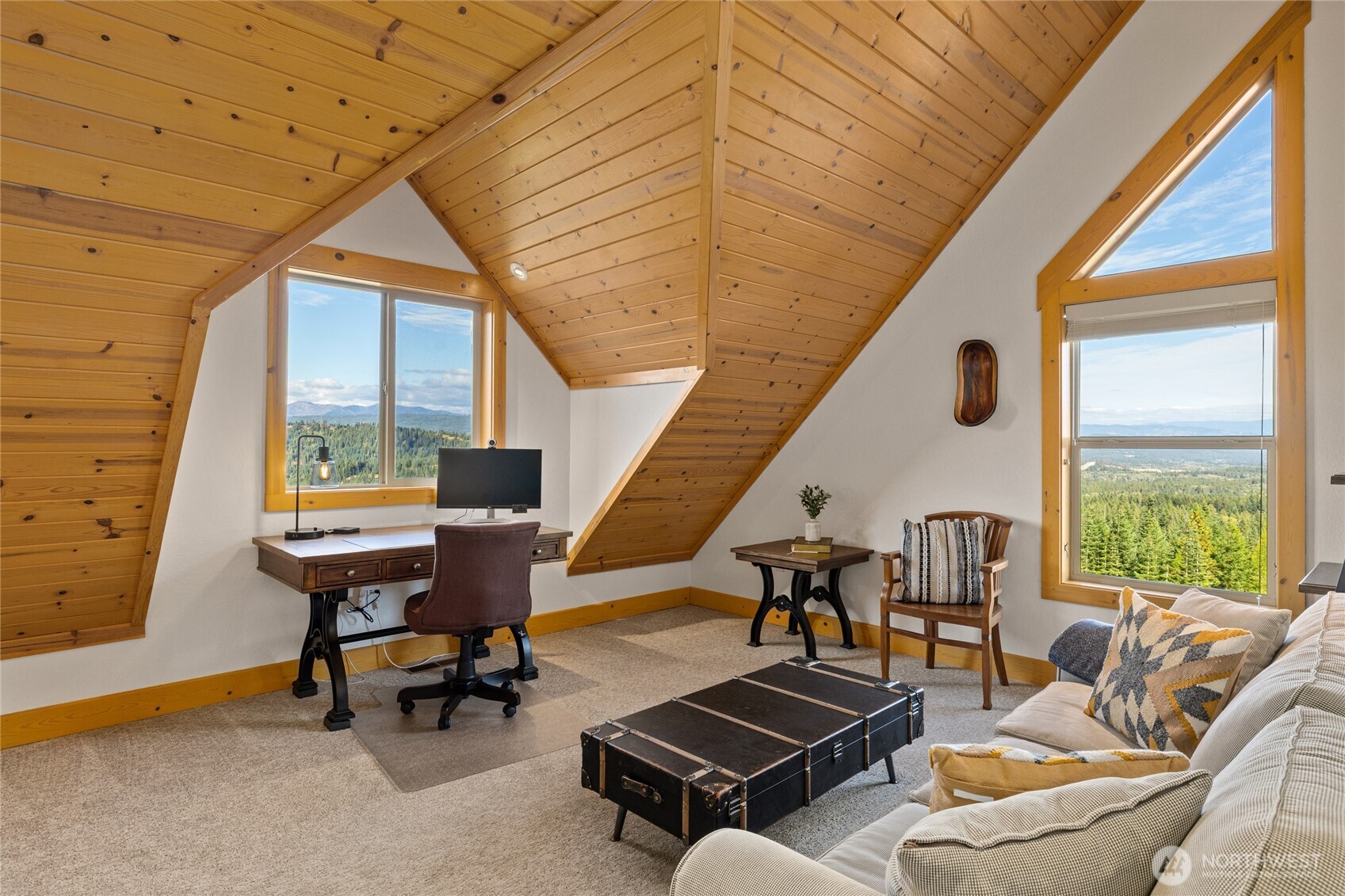 Spacious loft offers flexible space for an office, lounge, or additional gathering area, with impressive views from multiple windows.
