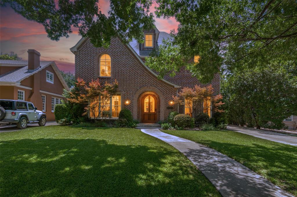 This storybook Tudor located in the heart of the Swiss Avenue Historic District was thoughtfully designed to complement the historic character of the neighborhood while offering the comfort and function of modern construction. A grand foyer with ten-foot ceilings, beautiful hardwood floors, and custom moldings sets the tone for a home that blends timeless architectural charm with modern living. The gracious formal dining room flows through a butler’s pantry into an eat-in kitchen with abundant counter space, generous storage, and an open connection to the spacious living area. Anchored by a fireplace and lined with expansive windows, the living area is filled with natural light and captures beautiful views of the thoughtfully designed backyard, where a covered entertaining space, sparkling pool, and relaxing spa create an inviting outdoor retreat for gatherings or quiet evenings at home. A first-floor office or study with a full bath can also serve as a bedroom. Upstairs, an elegant staircase leads to a large primary suite with an updated bath featuring marble floors, a steam shower, and a large walk-in closet. Two additional bedrooms share a convenient Jack-and-Jill bath, while an oversized flex space offers options for a media room, second living area, or additional bedroom. Enjoy exceptional walkability just steps from Skillman-Live Oak Center, Lower Greenville, and Lakewood Shopping, with easy access to White Rock Lake and its scenic trails. Set within one of Dallas’ most treasured historic neighborhoods, this home offers a rare connection to Swiss Avenue’s architectural legacy, vibrant nearby destinations, and enduring sense of community.