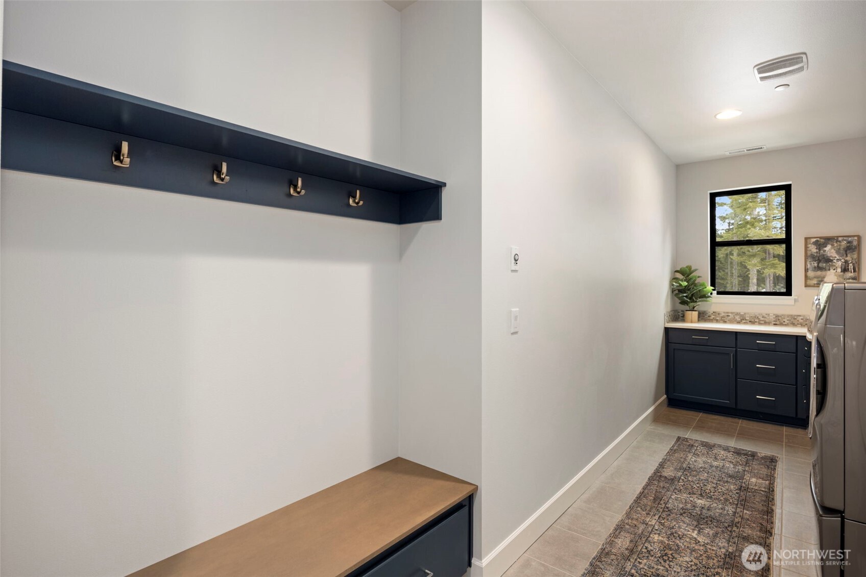 A convenient mudroom entry from the garage leads directly into the laundry room, offering plenty of additional storage and closet space to keep all your mountain gear organized and tucked away.