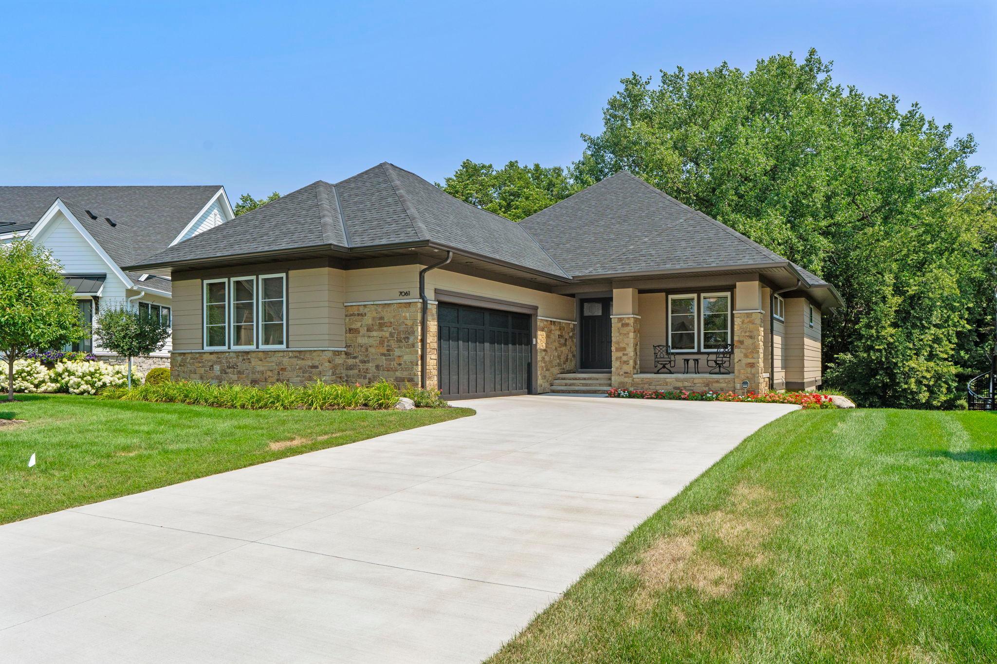 Welcome to this stunning custom-built 3 bedroom, 3 bathroom home in Eden Prairie, minutes from local shopping, dining, entertainment, parks, trails, and popular lakes. Beautiful craftsmanship and thoughtful design are showcased throughout, creating comfortable spaces for everyday living and entertaining.Step inside to soaring 11-foot ceilings in the living room with 9-foot ceilings throughout and an open main level. The foyer leads to a French-door office with a custom desk and shelving, while the kitchen, dining, living room, and sunroom flow naturally together. The kitchen features custom cabinetry, tile backsplash, center island, stainless steel appliances, and a custom butler’s pantry with a walk-in closet pantry. The living room offers a vaulted ceiling with wood beams, stone fireplace, picture windows, and custom shelving. The sunroom is filled with natural light and opens to the deck.The mudroom connects to the laundry room and finished, heated two-car garage with epoxy flooring, built-in shelving, sink, water spigot, extended ceiling height, and floor drain. A SecureAire whole-house air purifier was added in August 2025.The main-level primary suite offers backyard views, natural light, a walk-in closet, soaking tub, walk-in shower, and dual vanity. Downstairs, the spacious family room features a Sonos sound system, wet bar, and walkout access to the patio and yard. Two additional bedrooms, a 3/4 bath, fitness/flex room, and under-stair storage complete the lower level. Outside, enjoy the deck with a firepit gas rough-in and patio with a natural gas grill.