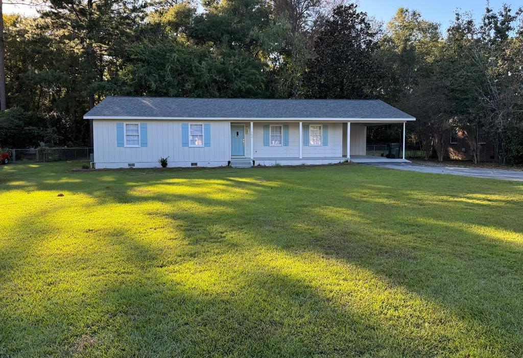 Charming Ranch Packed With Upgrades! Step onto the welcoming front porch, framed with cedar-style shakes, and enter through the robin's-egg-blue door into a beautifully renovated open-concept living and dining space. This delightful ranch has been completely refreshed inside — a true must-see! The brand-new kitchen shines with stainless steel appliances, including a side-by-side refrigerator, premium slide-in range, over-the-range microwave, and dishwasher. Luna Pearl granite countertops, abundant counter space, and a peninsula with counter-height seating make this kitchen as functional as it is stylish. New LVP flooring flows throughout the main living areas, while all three bedrooms feature plush new carpet. A spacious laundry room sits conveniently off the kitchen, offering ample storage options. The bright and airy living/kitchen/den area features a white brick wood-burning fireplace with a rich dark wood mantel for cozy evenings at home. Both bathrooms have been fully renovated with new vanities, mirrors, lighting, and durable, low-maintenance acrylic tub/shower systems. Additional upgrades include all-new lighting and ceiling fans, fresh door hardware, a new water heater, and a new roof. Enjoy outdoor living on the screened-in back porch, complete with a brick walkway and patio. The property boasts a large front yard and a spacious, fully fenced backyard with an irrigation system—perfect for a playset, trampoline, garden beds, or pets. A one-car carport plus extra parking adds everyday convenience. And best of all—NO HOA! This move-in-ready home blends charm, comfort, and modern updates. Don't miss it!  Convenient neighborhood, located just off Pinetree Blvd between Remington and Smith