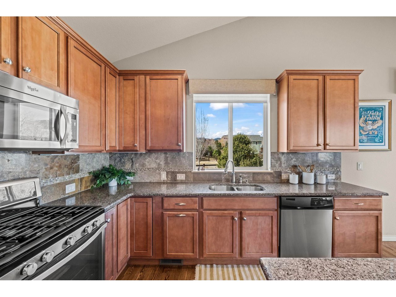Enjoy effortless main-level living in this thoughtfully designed ranch-style home, ideally situated on a corner lot in the sought-after Lyons Valley Park neighborhood. A welcoming covered front porch sets the tone, leading into a bright, open-concept floor plan highlighted by vaulted ceilings and abundant natural light. The well-appointed kitchen features warm maple cabinetry, slab granite countertops, stainless steel appliances, a gas range, and an oversized island-perfect for gathering and entertaining. It flows seamlessly into the spacious living and dining areas, complete with a cozy gas fireplace and custom built-ins. The main level offers two bedrooms, including a generous primary suite with vaulted ceilings, a luxurious five-piece bath, and a large walk-in closet. A versatile office or flex space with French doors provides the ideal setting for working from home or accommodating guests, while a convenient main-level laundry room adds to the home's functionality. Step outside to a large backyard and patio perfect for outdoor enjoyment, or furry friends. The full, unfinished basement presents endless possibilities for expansion, recreation, or additional storage. Perfectly located, Lyons Valley Park offers easy access to neighborhood parks, ponds, a dog park, scenic trails, the St. Vrain River, and local schools. Just minutes away, the charming Town of Lyons invites you to explore its unique shops, restaurants, and vibrant summer music festivals. Love Where You Live!