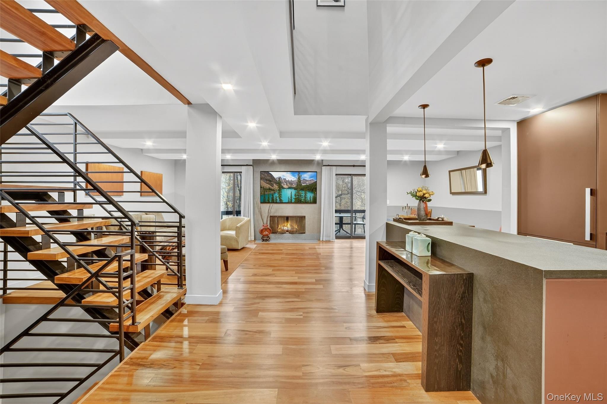 With absolutely stunning decor, this townhome offers the sleek, minimalist design that homeowners love, with abundant natural light, high end finishes, clean lines and an open floor plan. This end unit "sanctuary" offers great versatility, with 3 bedrooms plus two possible home offices, and 3 full plus one half baths. The array of designer elements is too long to list as nearly every element was customized to suit, with careful selection of colors and textures to impress the most refined taste. Embrace the Chef's kitchen where burgundy/ charcoal and natural earth tones mix, with custom cabinet faces made of European glass offsetting Miele appliances, Dekton countertops with a matching built-in table and dramatic floor-to-ceiling windows in the breakfast area. The Brazilian oak floors on both the main level and upstairs absorb your soft steps, while you move from dining room to living room, or beyond to the den (which can also be a home office, or 4th bedroom). The deck is perfectly situated off the dining area, affording views of the verdant lawn and natural wooded area further afield. Ascend a decorative floating staircase, to the private quarters. The primary bedroom was completely reimagined, with framing redone to create a vaulted ceiling and walls moved to fashion a study/meditation/yoga room. The luxury experience continues with a fully kitted out dressing area, and a knockout of a bathroom with soaking tub, seamless shower and two-sink vanity, set amid Porcelanosa tiles that infuse your bathtime with beauty. The other side of the hall features another fully tiled designer bathroom, laundry room, and a good-sized 2nd bedroom with double closet and two exposures. The lower level welcomes you with plenty of space to spread out in a family room with a wood burning stove and sliding glass doors, a 3rd bedroom with built-in closet and desk, plus another full bathroom that oozes "zen" from every corner of its bespoke workmanship. Stone Oaks is a gated community with 24 hour security and guardhouse, beautifully landscaped, where every homeowner has a private entrance. Community amenities include tennis courts, outdoor pool, clubhouse, gym, and sauna. Nearby to shops, restaurants and just 2 miles to the Hartsdale train. Completely move-in ready, this home truly offers La Dolce Vita in every way.