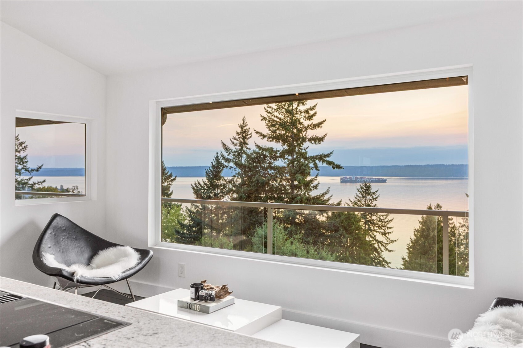 Live effortlessly in this fully-reimagined waterfront view home where modern design meets thoughtful comfort. Radiant  heated tile floors, custom-smoothed walls, and designer windows elevate every room. Entertain or unwind on the expansive 1,500 sq ft deck, overlooking gorgeous views of Puget Sound and the Cascade Mountain Range, or explore ADU potential in the versatile lower level. With a new 2024 metal roof, foam insulation, a glass-front Sub-Zero fridge, a wine cellar, and in-home gym -- No detail has been overlooked. Large detached garage perfect for collector cars or hobbies. The spacious backyard is a blank canvas for your outdoor vision. Don’t miss your chance to make this turnkey retreat your own—schedule your private tour today!