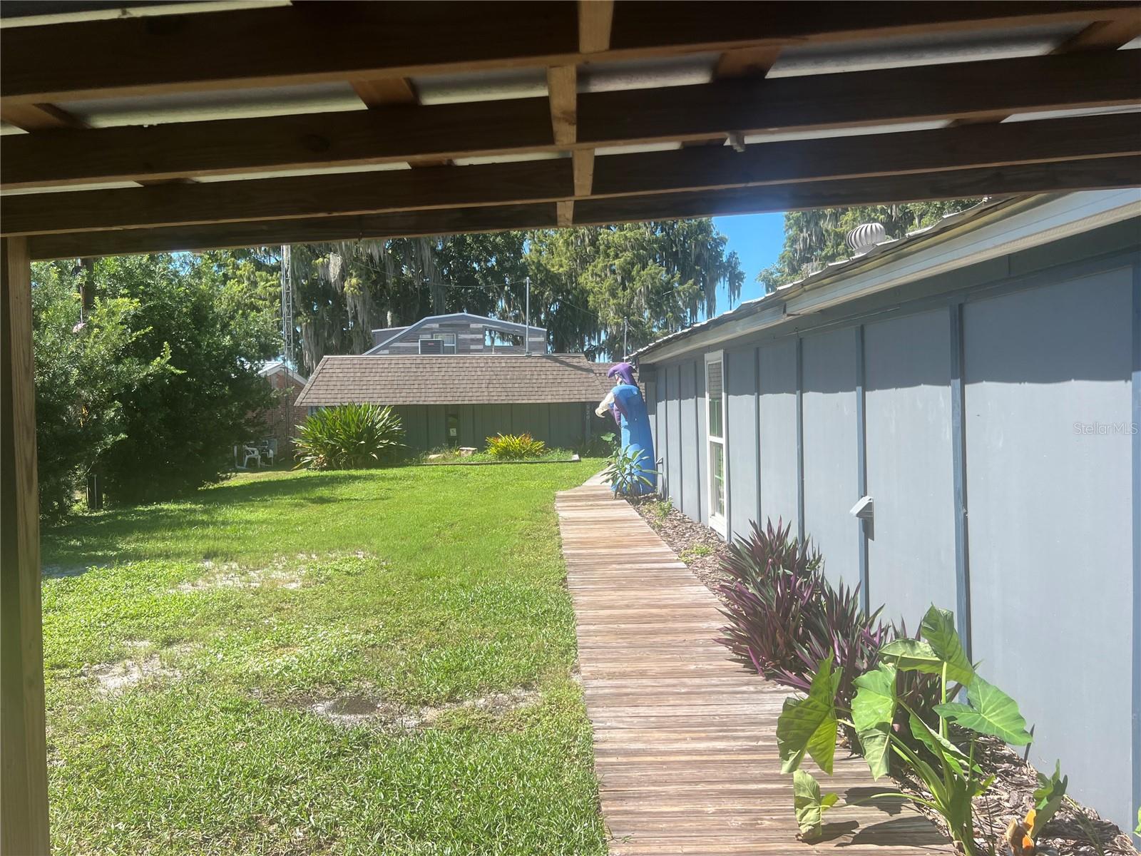 A rare opportunity to own a slice of Lake Tarpon Waterfront property with a Covered Dock. Main home consists of 3 bedrooms and 2 Bathrooms. Primary Bedroom is its own upstairs Suite with amazing views of the Lake. This is a true Lake House with a rustic cedar vibe throughout the home. The property includes an additional 2 Bedroom 1 Bath Home perfect for short term rental or family. Both homes can be leased year round either short term or long term or just make this incredible property your own. Main home boasts a very large game room with bar and sink perfect for entertaining. Neighborhood has its own private boat ramp to launch Jet skis or other water craft. This neighborhood will give you a country vibe but still close to all the stores and restaurants that Tarpon Springs has to offer. Dont miss out on this one.