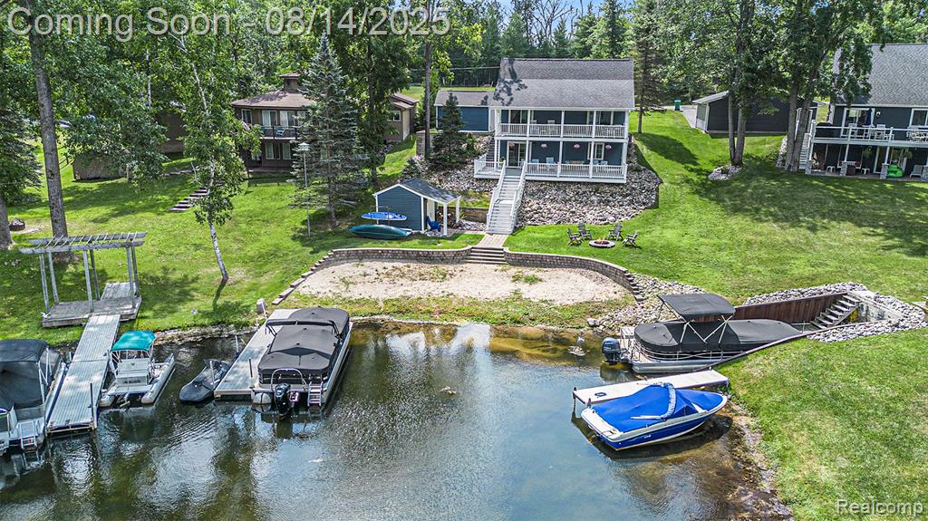 Enjoy lake life year-round in this 3-bedroom, 2-bath waterfront home on all-sports Lake Ogemaw with 77 feet of frontage! Inside, you’ll find a bright, airy atmosphere with a neutral palette, beautiful flooring throughout, and large windows that frame stunning water views. The living room features vaulted ceilings and a cozy fireplace, while the kitchen offers stainless steel appliances and plenty of space for cooking and gathering. Both bathrooms are finished with gorgeous tile work, adding a touch of style and comfort. Outdoor living is easy with a spacious deck, covered porch/balcony, and multiple outbuildings that provide ample storage for all your lake gear.