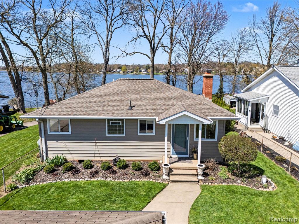 Enjoy lakefront living on all-sports Loon Lake with 86 feet of private frontage and stunning water views from nearly every angle. This well-maintained 2-bedroom, 3 full bath home offers over 2,100 square feet of finished living space, including a walkout basement designed for both relaxation and entertaining. The main living areas are filled with natural light thanks to an abundance of windows, perfectly framing the scenic surroundings. Vaulted ceilings in the family room create an open, airy feel, while the dining room features a cozy fireplace—ideal for year-round comfort. A neutral interior palette, freshly painted in 2024, provides a clean and modern backdrop ready for your personal touch. The finished walkout basement adds approximately 800 square feet of additional living space, complete with a full bath and flexible areas for recreation, guests, or hobbies. Outdoor amenities make the most of this prime lakefront setting, including a Trex deck, paver patio, fire pit, and a fenced-in yard. A circular driveway and extended cement path leading to the lake enhance both convenience and curb appeal. The 1.5-car attached garage adds functionality and storage. Key updates include a new water heater (2024), garbage disposal (April 2026), garage door opener (2021), furnace (2021), and roof (2013), along with a paver patio added in 2010. A rare opportunity to own a beautifully updated home with generous frontage on Loon Lake, offering the perfect balance of indoor comfort and outdoor enjoyment.