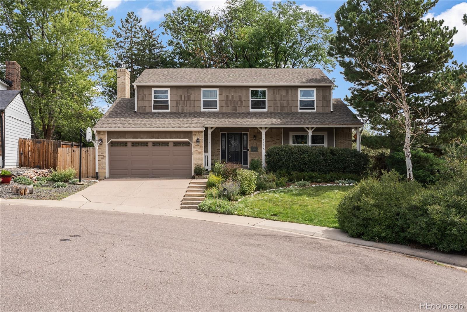 Great location within the Meadows neighborhood, sitting in a cul-de-sac nestled next to open space.Relax on the charming covered front porch with morning coffee or sunset views. The private, park-like backyard features mature landscaping, large patio, playset/tree house.The main level offers a functional layout with a living room, family room, formal dining and an eat-in kitchen with large windows looking out over the peaceful backyard, and an updated powder room. The kitchen is bold and eclectic with open shelving, red tile backsplash, and stainless-steel appliances. The family room has a wall-to-wall brick gas fireplace and is cozy and inviting.  Upstairs, the large primary bedroom that includes an updated en-suite, along with three good sized additional bedrooms, an updated full bathroom, and a convenient laundry area. This home has personality with tasteful wallpaper, engineered wood laminate flooring on both the main and upper level, window seats in the living and dining room. There are 2 EV Plug-ins in garage.The basement provides flexible space for a media, game, or workout room, plus a bonus room ideal for an office, den, or craft area and a half bathroom and spacious utility room for extra storage.The homes' location offers so much, walk to Eagle Meadows Park, walking trails, Sledding Hill Park, Denver Botanical Gardens Chatfield Farms, Deer Creek Canyon Park, shopping, restaurants and easy access to 470.