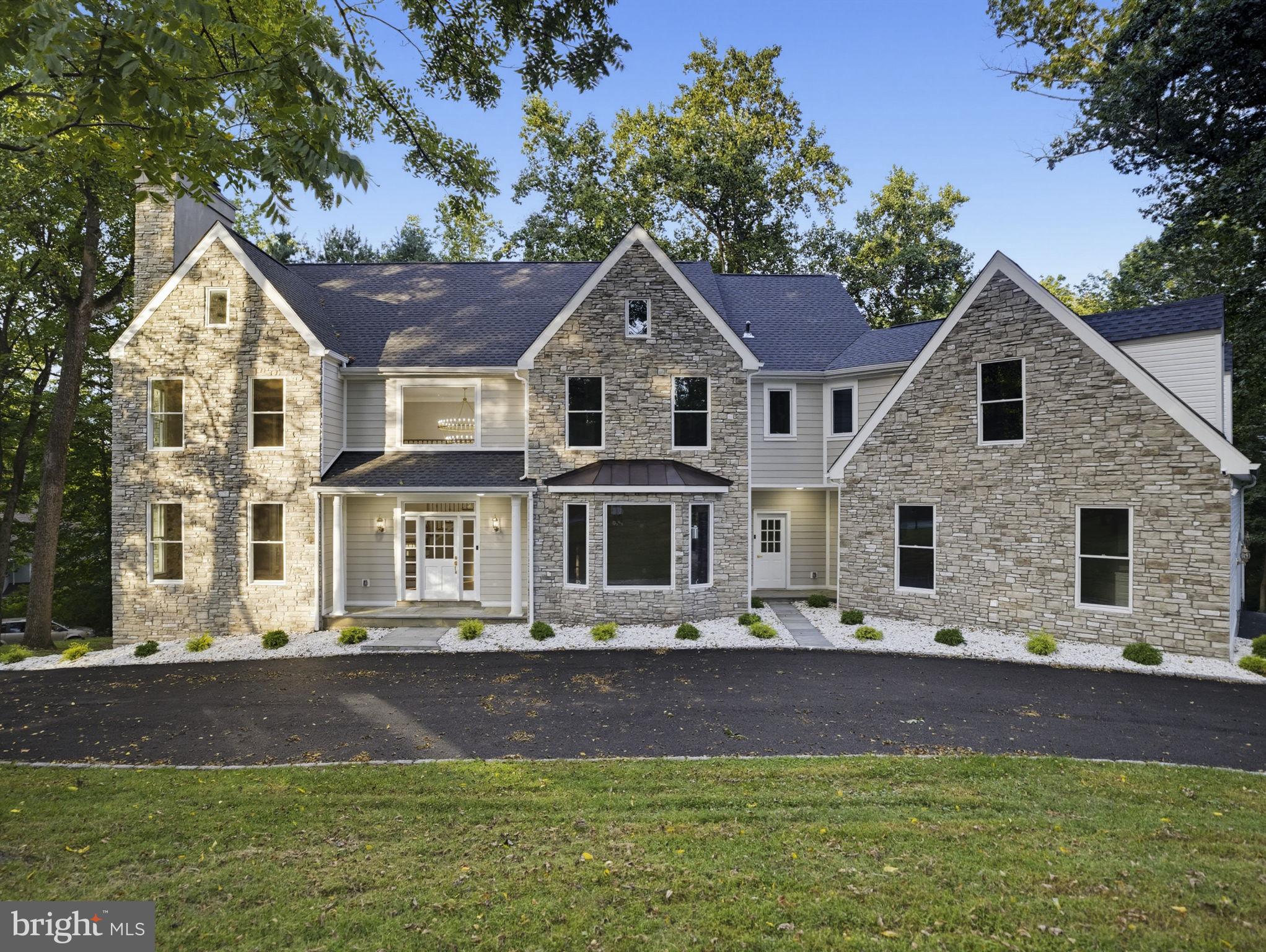 Welcome to 484 King of Prussia Road, a newly renovated luxury estate privately set back from the road on a spectacular 1.68-acre property in the heart of Radnor. Approached by a long driveway and surrounded by mature trees, this impressive custom-built residence offers exceptional privacy while remaining just minutes from everything the Main Line has to offer.Featuring 6,200 sq ft above grade plus an additional 2,100 sq ft of beautifully finished walk-out lower-level living space, this remarkable home offers 7+ bedrooms, 6 full and 2 half baths, and an exceptionally versatile floor plan designed for both everyday living and entertaining. Recent exterior and interior improvements include new stonework, Hardie Plank siding, a new roof, a beautifully renovated kitchen and bathrooms, new oak hardwood flooring, and updated lighting throughout, creating a fresh and sophisticated feel while preserving the home's timeless character.The classic two-story center-hall design welcomes you through an impressive foyer flanked by gracious formal living and dining rooms. The living room features a fireplace, while a separate home office provides a comfortable and private workspace. At the heart of the home is the expansive renovated kitchen, featuring a large center island, Café appliances, professional-grade cooktop, double wall ovens, built-in wine refrigerator, drawer microwave, and range hood. The spacious breakfast area easily accommodates a large table and opens through sliding Pella door to the newly built Trex deck overlooking the beautiful grounds.Adjacent to the kitchen is the dramatic great room, highlighted by a vaulted ceiling, Palladian window, and beautiful new oak hardwood flooring. A generous mudroom with convenient side entry, oversized laundry room, substantial pantry, and attached garage with interior access complete the main level.Upstairs, the primary suite occupies its own private wing and offers a spacious sitting room with gas fireplace, two walk-in closets plus additional closet space, and a beautifully appointed primary bath with a freestanding soaking tub, separate shower, double vanity, custom mirrors, lighting, and abundant storage. Four additional generously sized bedrooms are located on this level, three with private en-suite baths, along with an additional hall bath.The walk-up third floor provides even more flexible living space, including a 6th bedroom, lounge area with a built-in bed perfect for guests or sleepovers, custom built-ins, another full bath, and a large walk-in storage room.The extensively renovated 2,100-square-foot walk-out lower level is truly exceptional. Designed with a sophisticated Ralph Lauren-inspired aesthetic, fully furnished with high-end custom-made wood furniture, custom chandeliers and designer light fixtures, complemented by carefully selected wall décor, this level offers multiple spaces for entertaining and relaxing, including a TV and billiards room, cigar lounge, wine cellar, home gym, butler's pantry, additional office or potential 7th bedroom, and a full bath. Two fireplaces add warmth and character—one featuring a reclaimed barnwood mantel and another finished in marble. The lower level opens directly to a stunning covered bluestone patio with an additional wood-burning fireplace, creating an incredible indoor-outdoor entertaining experience. Outside, the 1.68-acre setting offers mature landscaping, generous new driveway parking, easy access around the property, and a private basketball/tennis court. Despite its secluded setting, the location is exceptionally convenient to downtown Wayne, Radnor Station, local dining, parks and walking trails, as well as many of the Main Line's highly regarded schools and universities. With over 8,000 square feet of finished living space, exceptional amenities, privacy, and convenience, 484 King of Prussia Road is a rare opportunity in the heart of Radnor. The home includes a two-year Select Home Warranty.