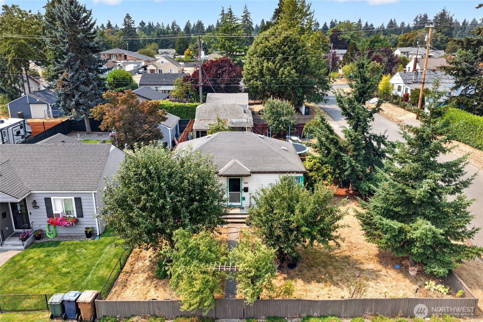 Opportunity awaits on this fenced corner lot in Tacoma! This well-loved 2-bedroom, 1-bath home offers a great starting point for your vision and the opportunity to add your own updates and personal touches. Features include hardwood floors, a mini-split for comfortable summer days, established fruit trees, and a detached garage with convenient side-street access. The garage and property may offer potential for a DADU—buyer to verify zoning, feasibility, and requirements with the appropriate authorities. Tenant occupied, so please respect their privacy and do not disturb. Priced to sell and ready for its next chapter—bring your ideas and create something special!