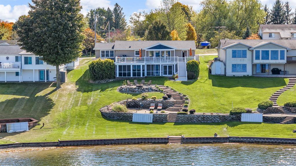 The ultimate lake retreat has arrived on private, all sports, Lake Somerset! Designed for effortless entertaining & relaxed sophistication, this low-maintenance home invites you to simply arrive & enjoy lake life. From the charming front porch swing to the open, coastal-inspired living, dining, & kitchen areas, all framed by panoramic, million-dollar views, every inch has been thoughtfully reimagined w/high-end finishes & amenities. The spa-like primary suite offers tranquil views, luxe bath, & walk-in closet, while a second romantic bedroom & full bath complete the main level. The lower level delivers a true entertainer's haven w/custom built-ins, a bar and pass-through window to the screened outdoor lounge. A gracious 3rd lodging space & bath combine for an inviting guest haven. Terraced stone patios cascade to your 75 ft of pristine frontage, perfect for soaking in sunsets, watching eagles soar & embracing the beauty of lake life at its finest. Back lot available separately too!