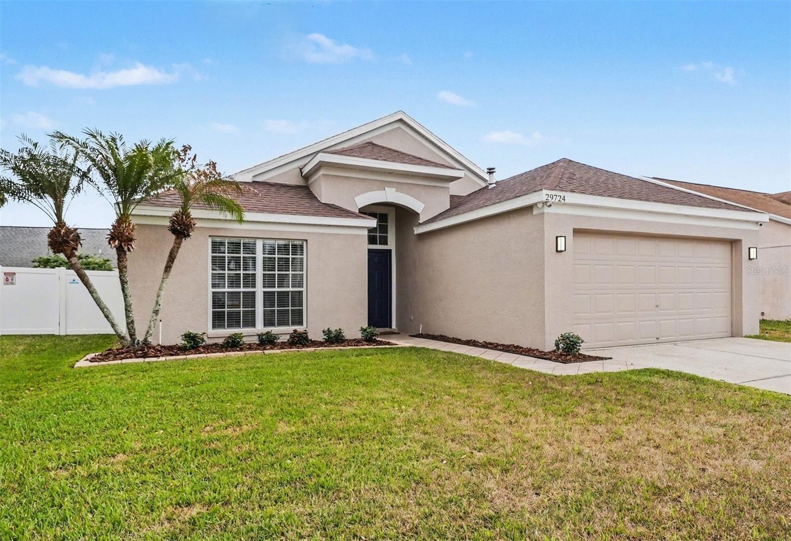 Welcome to this beautifully remodeled 4 bedroom, 2 bath home in Pasco County's Meadow Pointe neighborhood, known for its convenience, numerous amenities, and excellent schools.   This home has been COMPLETELY renovated, starting with durable, low maintenance luxury vinyl plank flooring and 5 1/4" baseboards throughout.  The fabulous kitchen now offers soft-close shaker cabinetry with pull-out shelving, a lazy Susan, pull-out trash bin, and under cabinet lighting.  The high end granite countertops with stylish backsplash and all new SS appliances including top-of-the-line Bespoke refrigerator and natural gas range/oven and Ultra Quiet dishwasher delight cooks of all levels.   There's even extra cold food storage in the garage's Vissani refrig and freezer.  Recessed LED lighting, new cabinet and door hardware, and updated plumbing and lighting fixtures have been added throughout.   The newly transformed primary bath includes an enlarged shower with two shower heads, special lighting, a fan, and a sliding door, eliminating the maintenance of a glass enclosure.   Both bathrooms showcase quartz countertops, new vanities and commodes, and LED lighted mirrors.  Special touches have been incorporated such as trim work around windows and doors, ship lap in the kitchen and baths, and sliding doors replacing swing doors.  No detail has been overlooked, including a Nest thermostat, security system with 4 cameras and video surveillance, and a Home Theater surround system.  The complete interior has been freshly painted, exterior painted 2022, new roof 2018, gas water heater 2023, and Rheem A/C with gas furnace 2017.  Meadow Pointe II offers a clubhouse with lighted pickleball/tennis and basketball courts, state-of-the-art fitness center, a resort style pool with splash pad, and a covered playground.   This home is very convenient to Bruce B. Downs and I-75, New Tampa/Wesley Chapel's restaurants and shopping, and new medical facilities. This is not a fix and flip, this is the original owner taking great pride in ownership.  Call for your private tour today!
