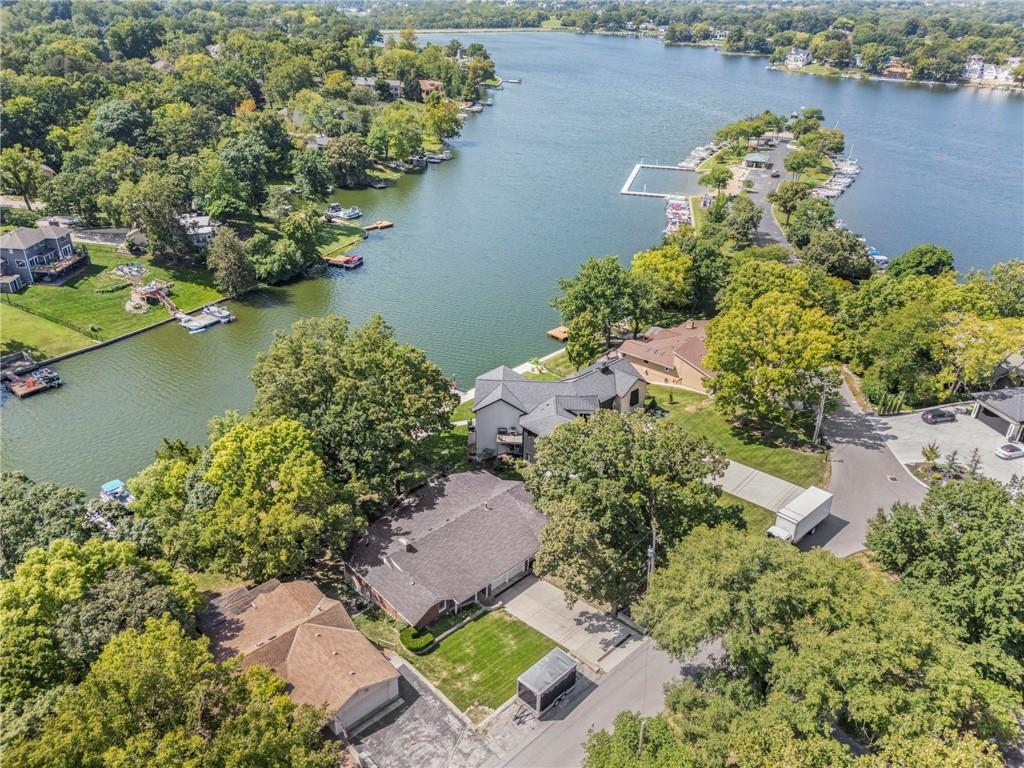 Rare lakefront opportunity in the sought after Lakeview subdivision of Weatherby Lake! Situated on one of the community’s most desirable homesites, this well maintained ranch offers nearly 100 feet of shoreline, a private dock and expansive water views extending all the way to the dam. Enjoy lakefront living from the covered deck or the huge open deck overlooking the 274-acre private lake. The home features three bedrooms, three bathrooms, vaulted ceilings, an expansive kitchen and a private primary suite. The walkout lower level provides additional living and entertaining space with convenient access to the lake. While there is an opportunity to add your own personal updates, the home has been exceptionally maintained and is move-in ready. Located just a few homes from C-Point Community Pavilion, a private beach and swimming area, with additional docks available for rent. Weatherby Lake offers an active community lifestyle with numerous activities throughout the year, including an Easter egg hunt, barbecue competition, Fourth of July celebrations, ice cream socials, Trunk or Treat and a Christmas extravaganza. Located in the Park Hill School District and just minutes from Zona Rosa, Kansas City International Airport and downtown Kansas City. An extraordinary opportunity to enjoy waterfront living, beautiful views and an exceptional lake community! The seller's have never occupied the home and Buyer's and/or buyer's agent must verify all information. Home is being sold in it's present condition.