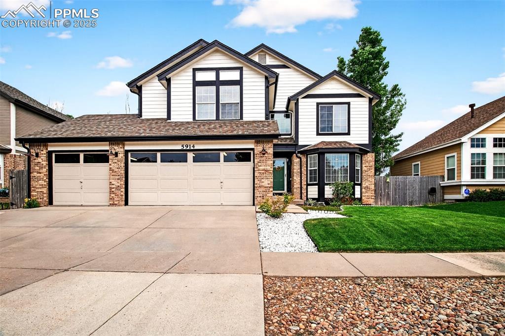 WELCOME HOME!!  This stunning 2 story is spacious and well-maintained. The home boasts a soaring ceiling in the family room, 5 bedrooms, 4 bathrooms, offering ample room with a large 3 car garage. This home combines practical living spaces, like a central kitchen, cozy fireplace, a deck and lots of light- with conveniences such as a fenced yard and proximity to schools, shopping, movie theater, dining and Powers corridor.  New exterior paint July 2025, whole house humidifier, whole house fan, central air conditioning, walk in closet in primary bedroom, a bedroom with attached 3/4 bathroom on main level, or can be used as an office, basement has a large area with a wet bar, tons of storage, newer carpet, washer and dryer area, along with a bedroom with attached bathroom. The mud room is off garage with storage. The backyard is the perfect spot to sit on the deck and watch the fireworks across the street at Weidner Field, while the patio area has plenty of room for entertaining and outdoor dining.