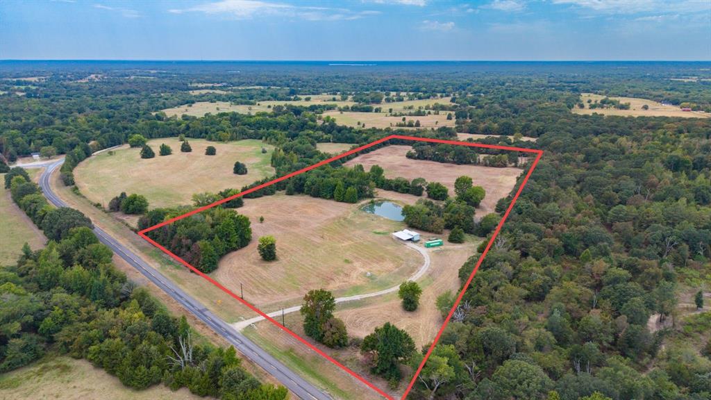 Multi-use property that is ready to go! Here is 24.65 ag exempt acres that offers the opportunity for full time living (2024 nice furnished tiny home in place (with all utilities) or several great locations to build a new home or a property is already set up for that weekend getaway and a great hunting place. There is a 2 year old well (approximately 500' deep) for great fresh water from the Carrizo Wilcox aquifer, The tiny home has everything you need with a loft for the kids or extra storage space and with a large trex built front porch and custom built all metal carport overlooking a beautiful pond area nestled between the trees. There is also a shipping container on site for extra storage. The natural beauty of this quiet property make the opportunities endless. Bordering this tract to the north is a large tract (currently owned by the school) improving your privacy and hunting habitat. The good sandy loam soil is great for a few animals, wildlife habitat, productive grass and even  a garden spot. Also, a good base rock drive is in place for easy access. Located only 15 min. from Sulphur Springs and 10 min. to Winnsboro for shopping, activities and great restaurants. Also, only a short drive for great fishing and water fun at Lake Winnsboro, Lake Quitman, Lake Cypress and great fishing atLake Fork. NO KNOWN RESTRICTIONS!NOTE: approximately. 1 acre of this tract sits across the FM.