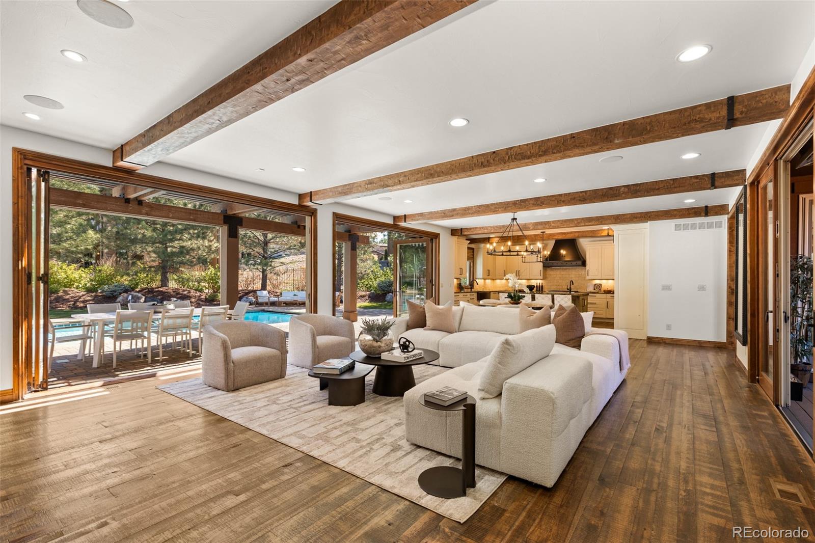 Nestled on a private cul-de-sac in the coveted gated community of Heritage Hills, 9316 Vista Hill Way is a masterfully crafted 5-bedroom, 7-bathroom residence built by Celebrity Homes in 2017. Designed for seamless indoor-outdoor living with a $200,000 renovation including the addition of dual Nano doors, pergola with privacy shades, Stone accent wall and linear fireplace and kitchen updates. Also featured is an expansive covered outdoor lounge with built-in heaters and a projector screen—ideal for evening movies under the stars.Inside, custom hardwood floors, knotty alder doors, black iron accents and fresh new paint create a warm, refined ambiance. The gourmet kitchen boasts Sub-Zero and Wolf appliances, a spacious walk-in pantry, and opens to a large great room leading to a backyard oasis—complete with a pool/electric pool cover, hot tub, putting green, and al fresco dining.The luxurious primary suite offers a private sitting area with beverage center, dual custom walk-in closets, oversized copper tub, heated floors and direct access to the pool and spa from a private balcony. Two additional en-suite bedrooms are located upstairs along with a convenient second-floor laundry, and media room, while a guest en-suite resides on the main level.Additional highlights include a custom 1500 bottle wine room, 4 Car garage with epoxy floors and built-in cabinetry, and a large basement featuring a river rock bar with raw-edge granite, beverage center, dishwasher, refrigerator, and ice maker and a spectacular mirrored home gym, and ample space for indoor/outdoor entertaining. Additionally, the interior courtyard has been thoughtfully transformed into a private basketball court, a perfect complement to the expansive lower level for a sports lovers dream!Located minutes from I-25, C-470, and the Denver Tech Center, and close to restaurants, shopping, trails, tennis courts, and community amenities—this home is the perfect blend of luxury, comfort, and lifestyle!!