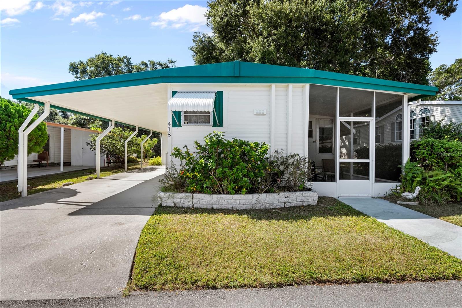 Welcome to 585 Sky Harbor Drive, a charming opportunity in Clearwater’s beloved Sky Harbor 55+ waterfront community. Nestled along the coast, this mobile home offers a relaxed lifestyle with practical perks and serene surroundings. A great opportunity to own a piece of Florida's land with NO land lease here.  This home also features an extended lot backing to the community wall with no direct backyard neighbors.  This home is ready to move into and ready for your personal touch.  While the roof age and ac are unknown, no issues have been reported.  Inside, you’ll find the home features wood flooring and an abundance of windows that fill the space with natural light, enhancing its coastal charm. A thoughtfully enclosed porch expands the interior living area to the mid-700s square feet, offering added flexibility for lounging, hobbies, or hosting guests. A carport area protects your vehicles and golf carts are welcome.  There is also a shed for your storage needs. The laundry hookups are in part of the air conditioned unit in the added enclosed sunroom area.  Find some peace of mind in knowing there was NO major community damage or flooding from the past hurricane season/s! This home is situated in the sought-after waterfront active 55+ community of Sky Harbor Estates, and is part of a deed-restricted neighborhood that offers a welcoming atmosphere and a variety of clubhouse activities. Discover the stunning pool and shuffleboard court that overlook Tampa Bay and the Tampa skyline. Take your kayak to the private launch and experience the peaceful waters of this exclusive spot. With these amenities and breathtaking views, you will truly appreciate the beauty of this waterfront community.  Conveniently positioned near shopping centers, bus stops, restaurants, two airports, beaches and more. The HOA fees are 295/month and include water, sewer, trash, pool, and club house maintenance. Don't miss out on this opportunity to enjoy Florida's breathtaking scenery and warm weather!  Schedule your private showing today!  Cash transactions only, no financing options are available.