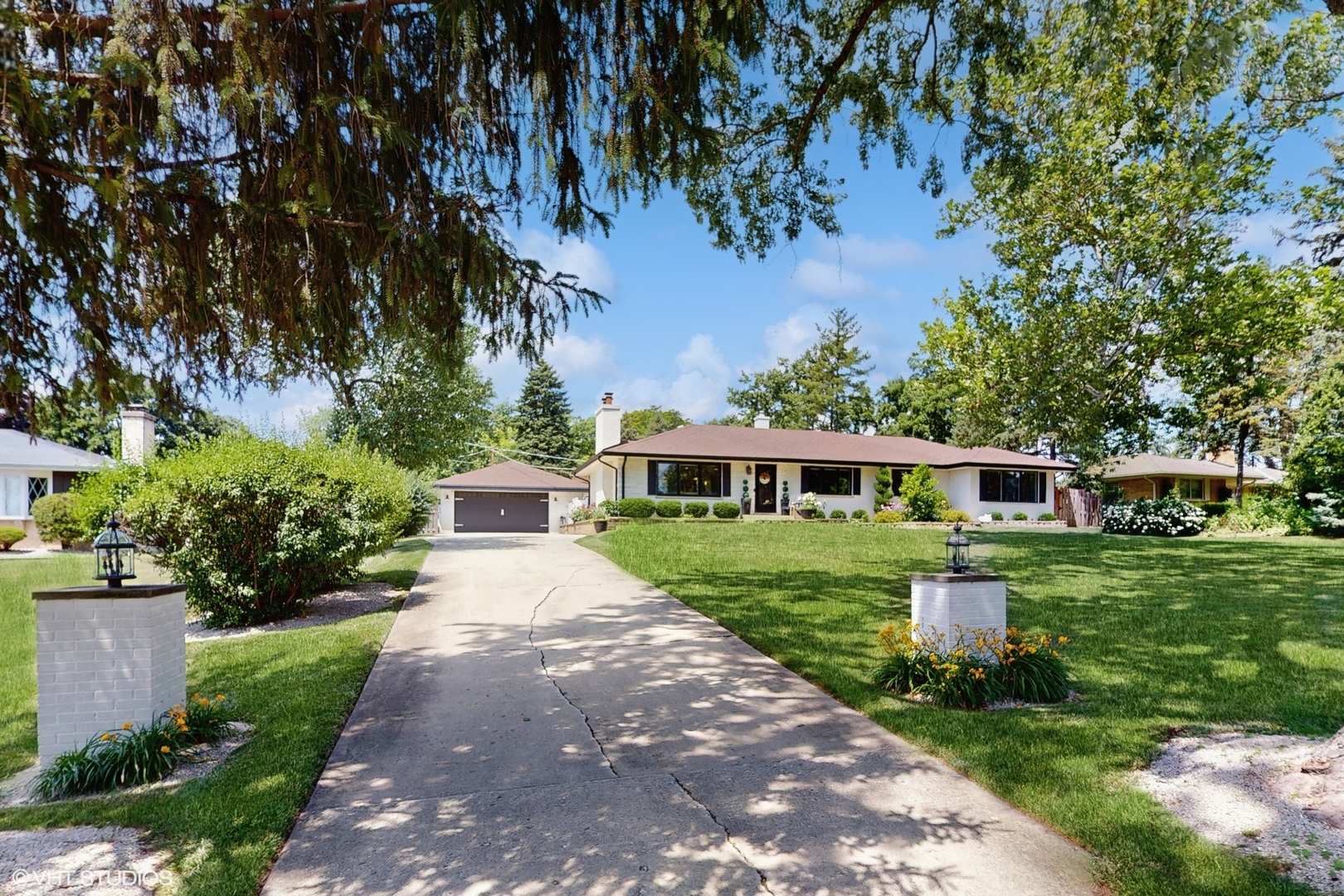 Stunning turn-key California ranch perfectly situated on an expansive Glen Ellyn lot, blending modern luxury with timeless charm. Fully renovated in 2024, this home was redesigned with sophistication and comfort in mind. The heart of the home is the custom chef's kitchen, featuring high-end built-in cabinets and appliances, including a custom Sub-Zero refrigerator, an oversized 6-person island with extra-thick quartz countertops, and white oak accents that complement the living room's sleek, slatted wood design. The open-concept layout is ideal for entertaining, with restored hardwood floors, contemporary lighting, and designer finishes throughout.  The spacious primary suite offers a private retreat with a cozy sitting area, large walk-in closet, and spa-inspired en-suite bath complete with double vanity, walk-in shower, and a soaking tub. The finished basement adds incredible versatility with two large living areas, a fireplace, a full bedroom, and ample storage, including a dedicated storage room.    Step outside to a private backyard oasis featuring a stamped concrete patio, in-ground pool with a new liner, pergola/gazebo entertainment area, greenhouse, and two sheds. The fully fenced yard and gated courtyard provide both privacy and charm. Permanent soffit lighting adds year-round curb appeal and eliminates the hassle of hanging holiday lights. This home is truly move-in ready and offers luxury living both inside and out, all in a coveted Glen Ellyn location.