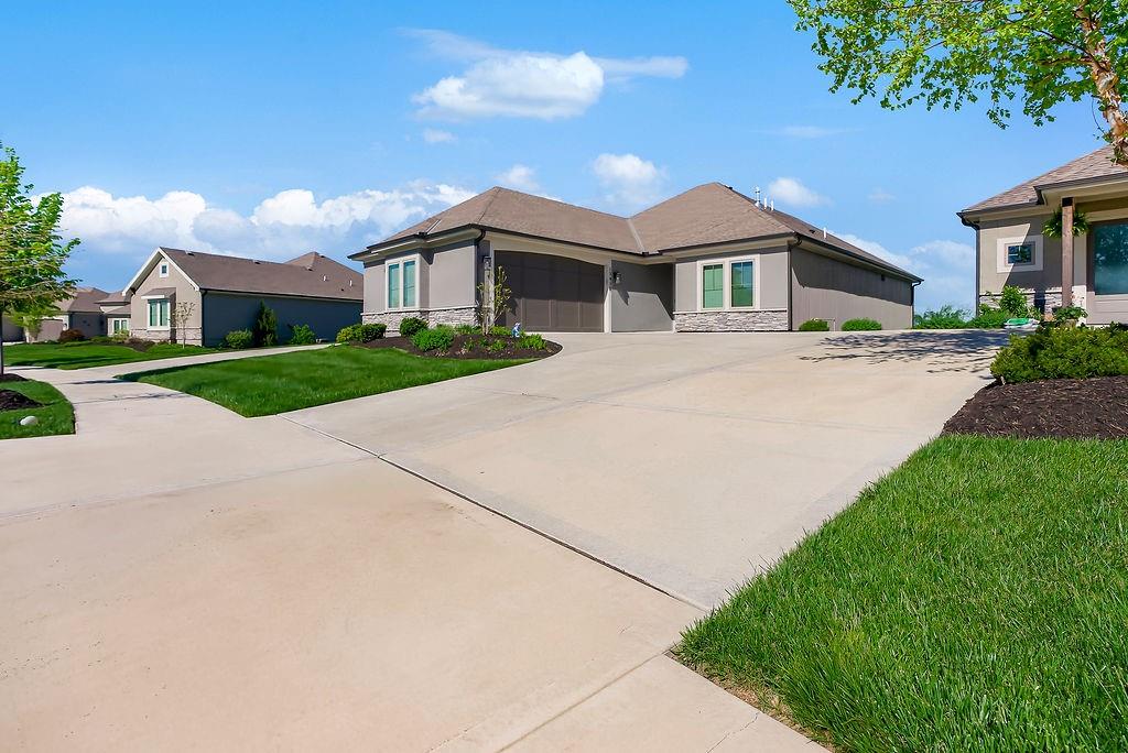 Welcome to the extremely popular Willow plan by renowned builder JFE on a highly sought after walkout lot. This is your opportunity to purchase an almost brand new home without the long wait to build or all of the decision making! Customized features of this particular villa include an oversized 8ft kitchen island to accommodate additional seating. Upgraded Calacatta Laza quartz countertops and backsplash in the kitchen as well as the main floor guest bathroom and lower level bathroom.  Custom hood vent. Samsung 5 burner gas cooktop. Stainless steel GE Profile dishwasher, microwave and oven. Convenient additional outlets in pantry for small appliances or coffee bar. Soft close doors and drawers throughout main level. Over $1300 in upgraded light fixtures from Rensen House throughout the home. Water softener and whole house water filter installed. Almost $6,000 worth of custom shades installed throughout main level. Oversized Carver 5'11 bathtub in primary bathroom with custom wainscoting surround. Waterfall showerhead in primary shower. Upgraded height and length of toilets throughout. Custom game closet in unfinished storage area for more wall space in lower level living room.Additional features in the Willow plan include: HVAC - 92% Furnace / 13 Seer AC with humidifier. 50 Gallon Gas Water Heater. Roof- 30 Year Tamko Asphalt Shingles. Radon Vent Pipe for Future Hook-Up (No Fan/No Outlet) All Bedrooms / Living Room Wired for Fan / Light. 36" Living Room Gas Fireplace. Zero Entry Garage / Zero Entry Stoop. Box vault ceiling in dining room and primary bedroom. 12 X 14 covered deck and patio. Wood wall feature and zero entry shower in primary bedroom. Please see supplement "willow 21R price sheet" for many additional features and details. This incredible quality villa, at this price, in this location is a don't miss!